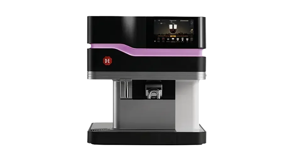 A modern coffee vending machine with a black and silver exterior and a purple accent. It has a digital display screen at the top and a dispensing area in the middle.