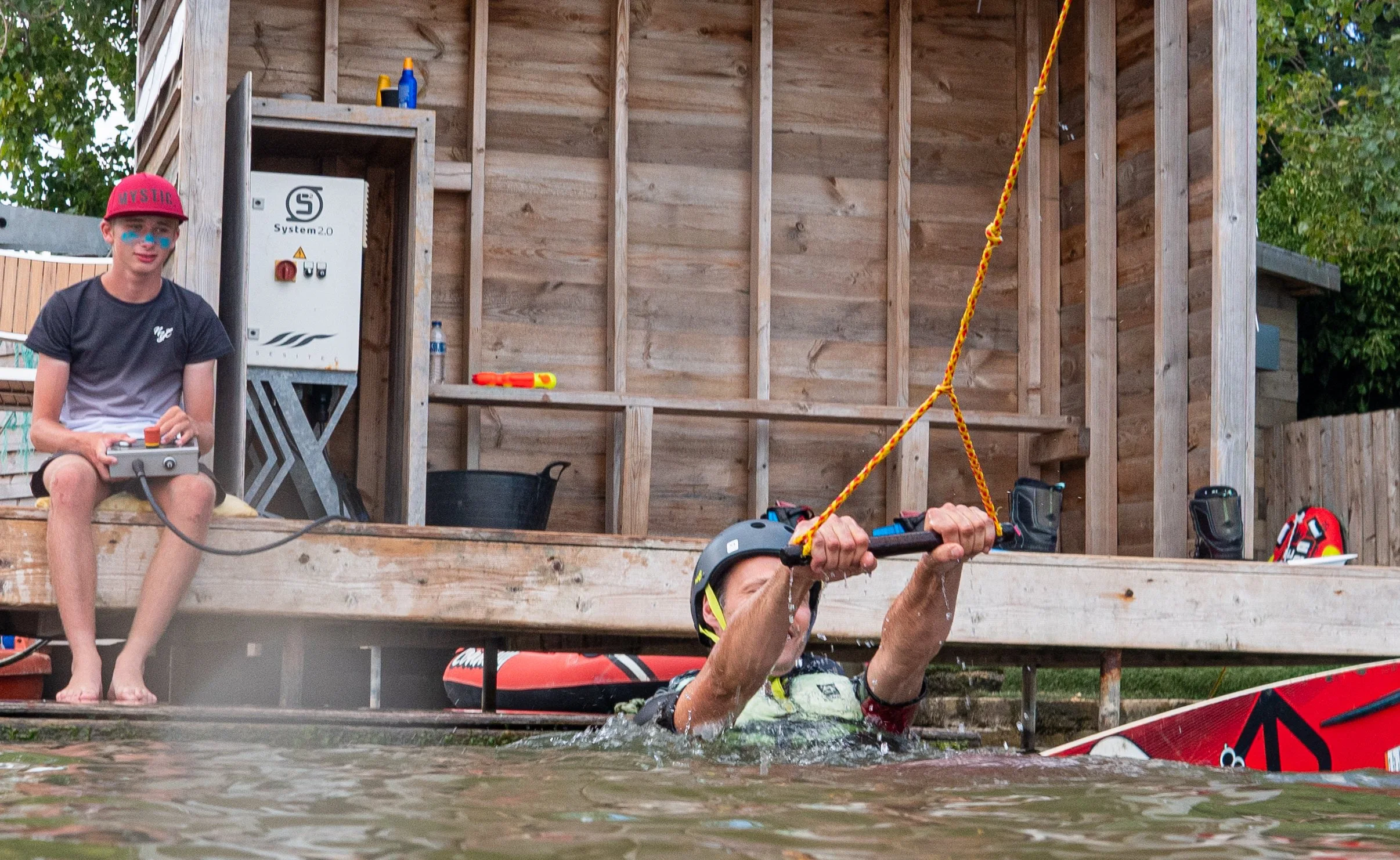 A man learning to wakeboard with one of our experienced coaches at Curve Water Sports Essex