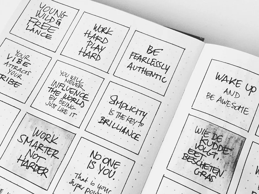 Handwritten motivational quotes page with inspirational messages arranged in boxes.