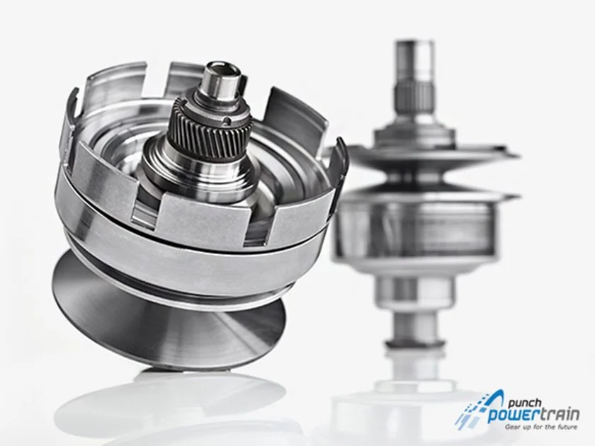 Close-up of a metallic Turbocharger component with a blurred background showing the brand logo Punch Powertrain.