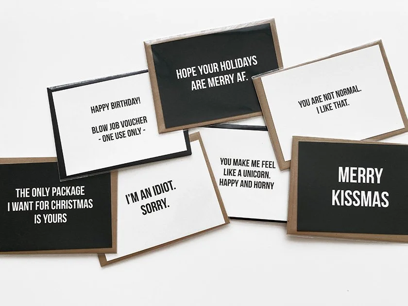 A collection of black and white greeting cards with humorous messages on a white background.