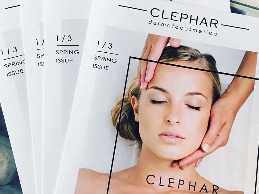 Several copies of a magazine titled 'CLEPHAR dermatocosmetica' featuring a woman receiving a facial massage on the cover.