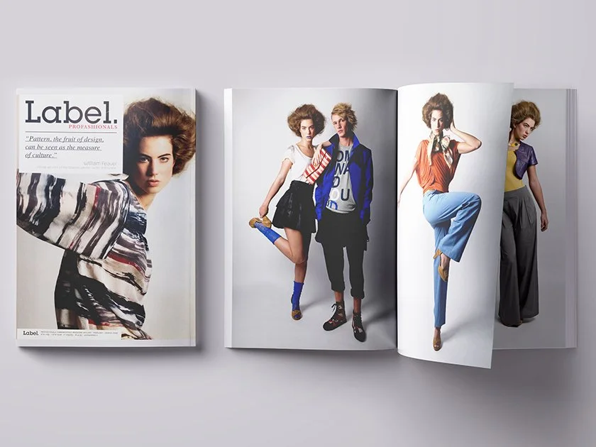 Open fashion magazine displaying models in colorful, stylish outfits on white background.