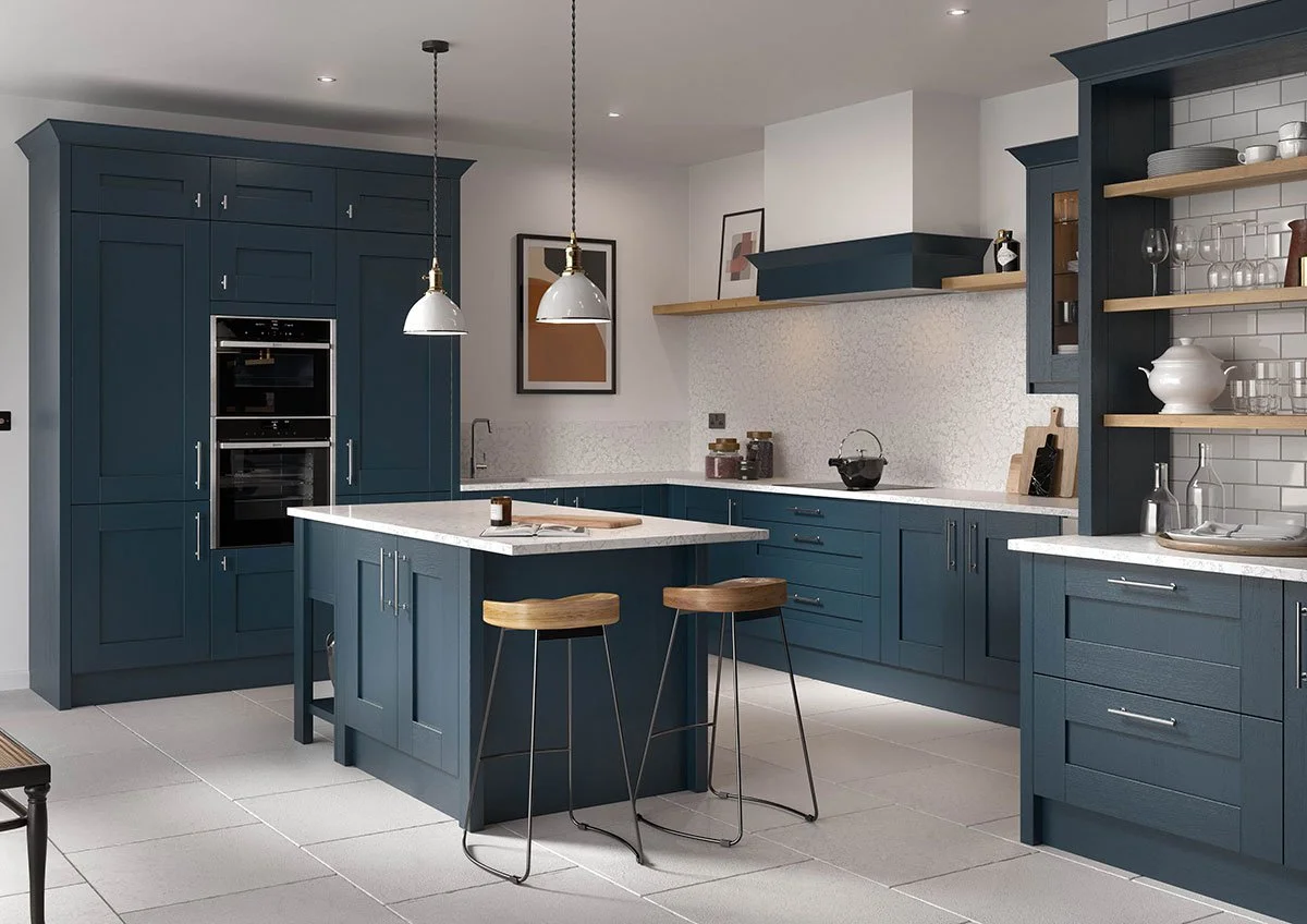 Modern kitchen with blue cabinets, white countertops, open shelving, and a kitchen island with two wooden barstools.