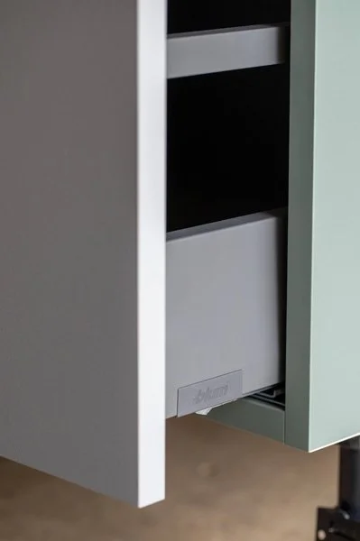 Part of a kitchen cabinet with door open, revealing a built-in dishwasher.