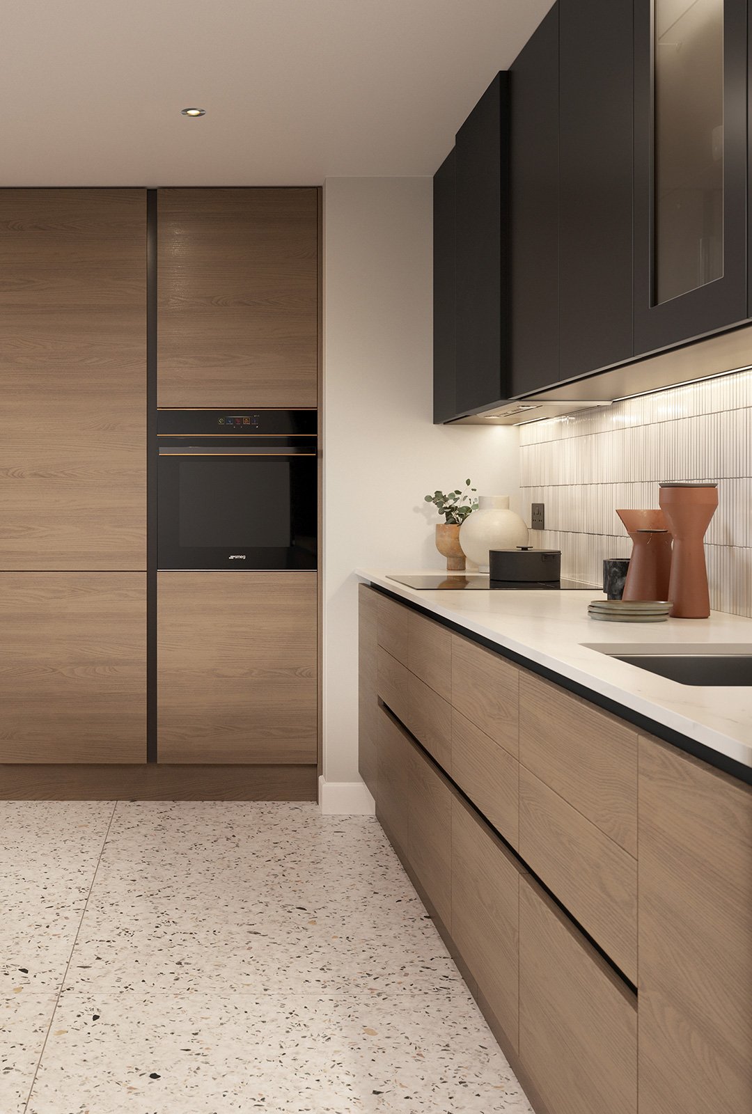 Modern kitchen with light wood cabinetry, black upper cabinets, white countertops, and decorative clay vases and pottery on the counter.