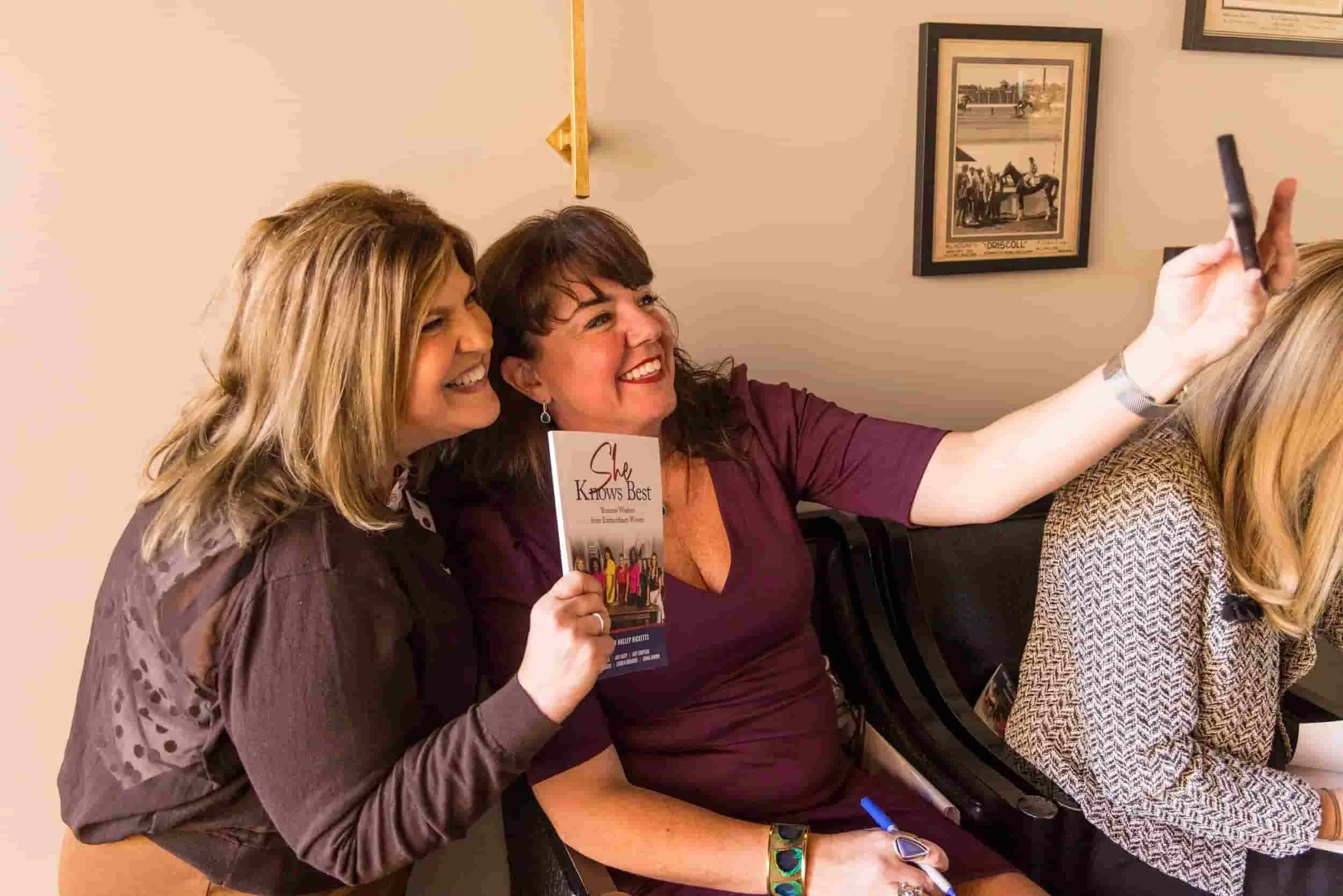 She Knows Best author Molley Rickets posing with fan.