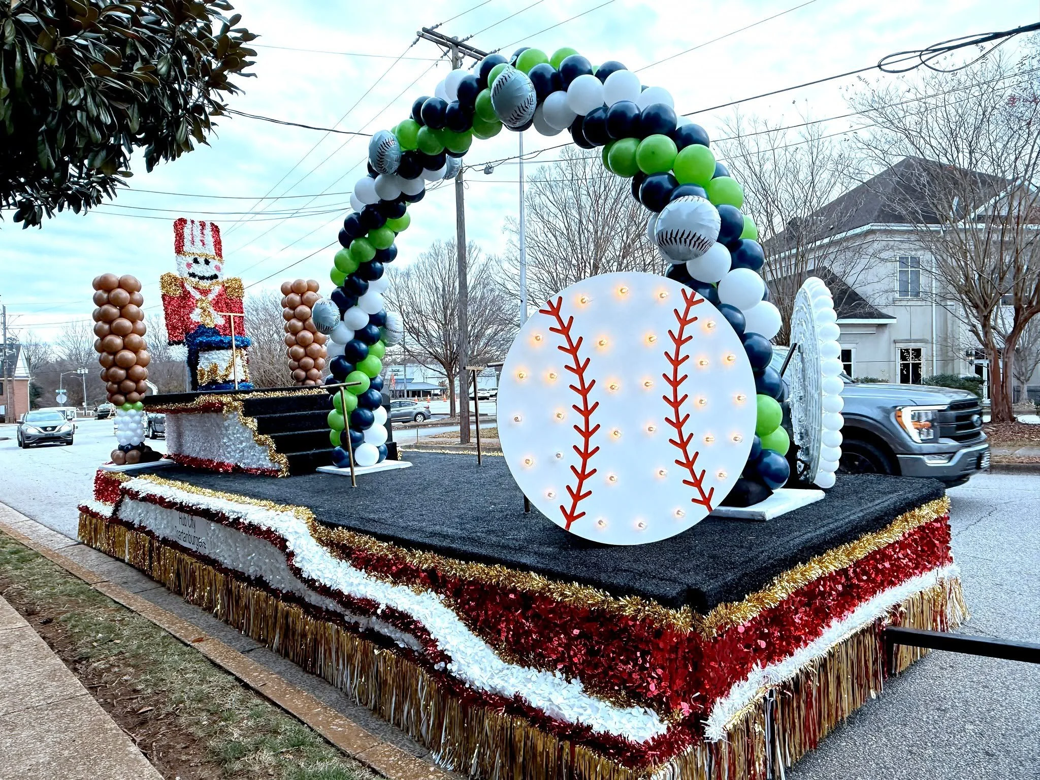 Balloon decorations for the Hub City Spartanburgers&rsquo; Christmas float 🎄⚾✨ Featuring our 4' marquee baseball, balloon baseball, baseball bat columns, and a festive balloon arch, this float was a home run way to spread holiday cheer throughout th