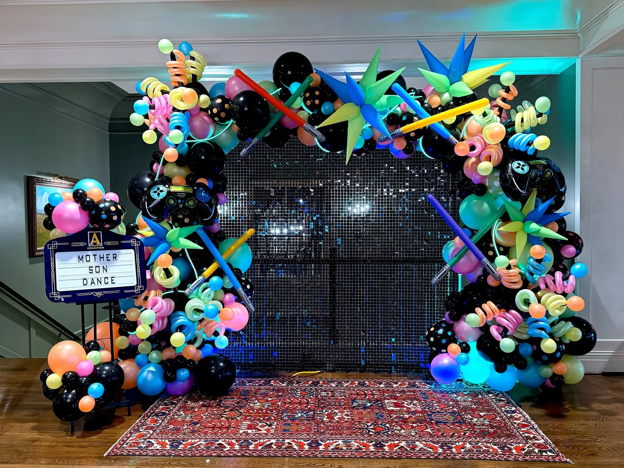 Decorations for a Laser Tag / Game&ndash;Themed Mother Son Dance at the Greenville Country Club 💚🎮✨ Featuring a shimmer wall, neon balloon garland, and floating neon helium balloons, the d&eacute;cor created an exciting, glow-filled atmosphere perf