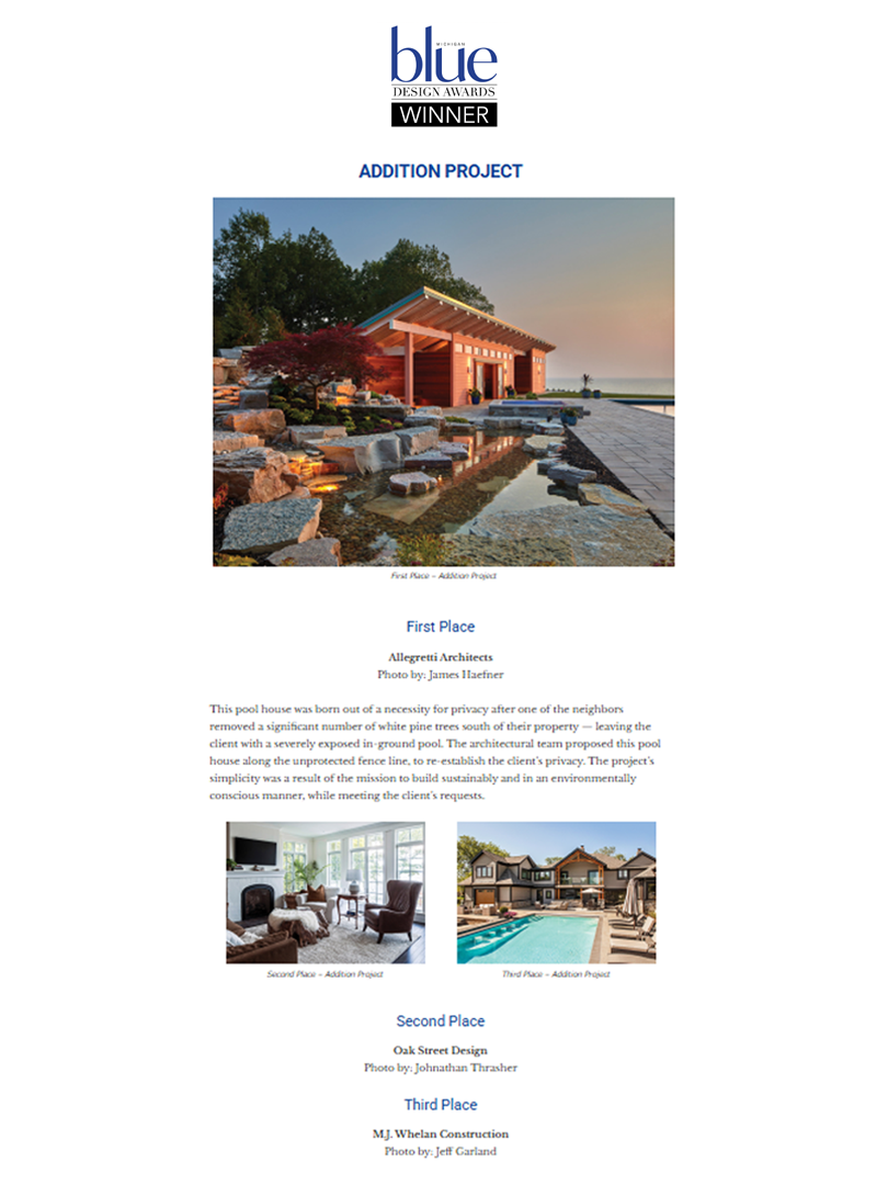 A large white house with multiple levels, balconies, and a steep, gabled roof, situated on a hillside surrounded by trees and a wooden staircase leading up to it.