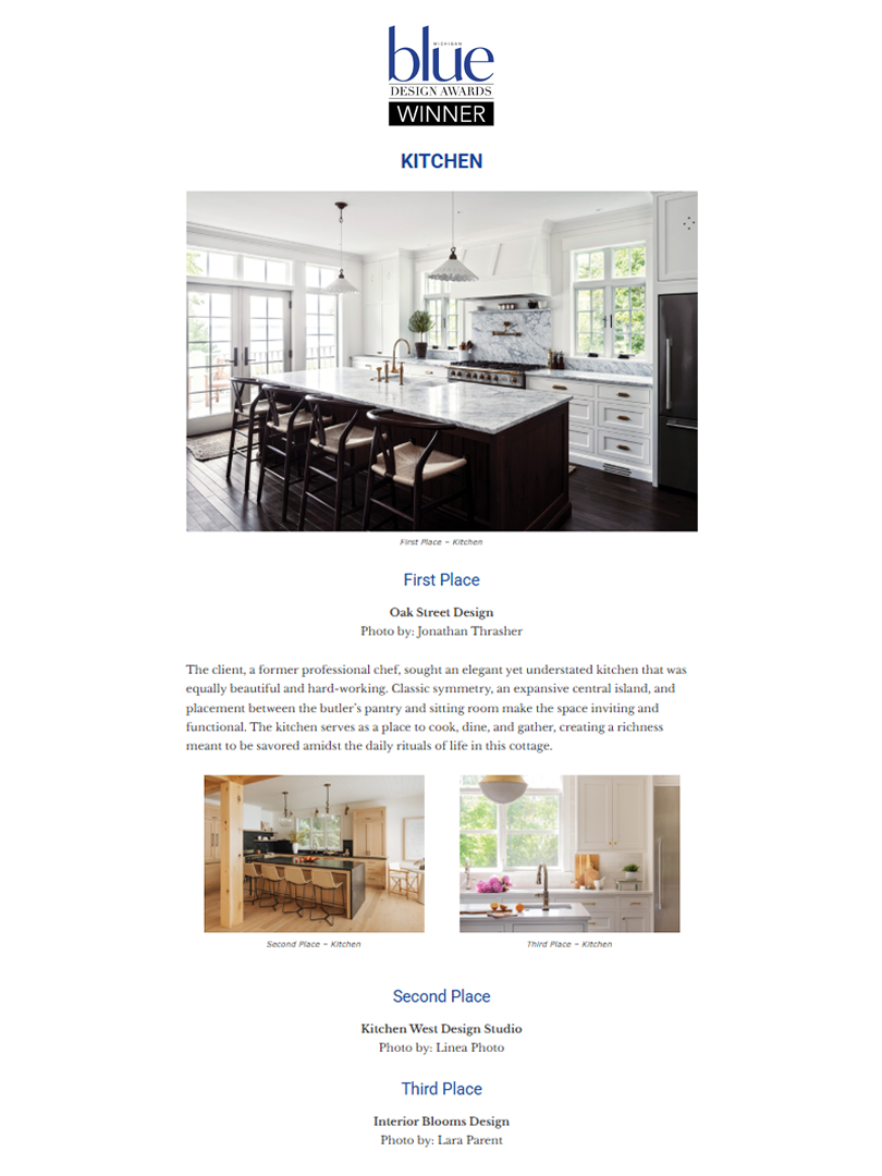 A large white house with multiple levels, balconies, and a steep, gabled roof, situated on a hillside surrounded by trees and a wooden staircase leading up to it.