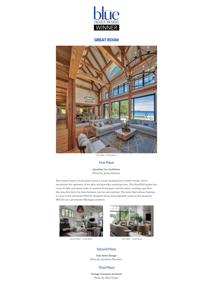 A large white house with multiple levels, balconies, and a steep, gabled roof, situated on a hillside surrounded by trees and a wooden staircase leading up to it.