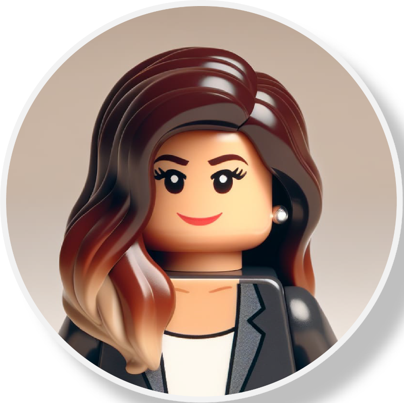 Lego figurine of a woman with long wavy brown hair, wearing a black blazer, white top, and pearl earrings, smiling.