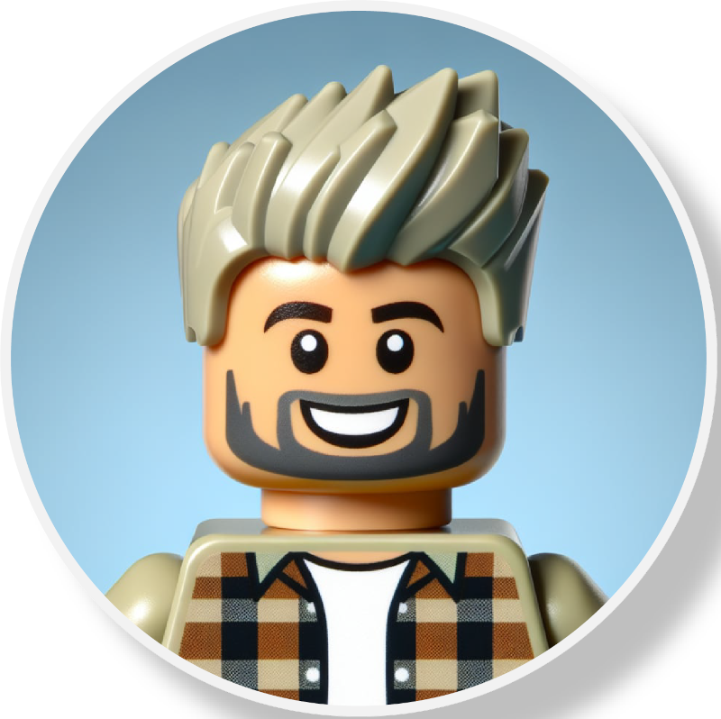 LEGO minifigure with spiky blonde hair, a beard, smiling face, wearing a brown and black checkered shirt over a white T-shirt, against a light blue background.