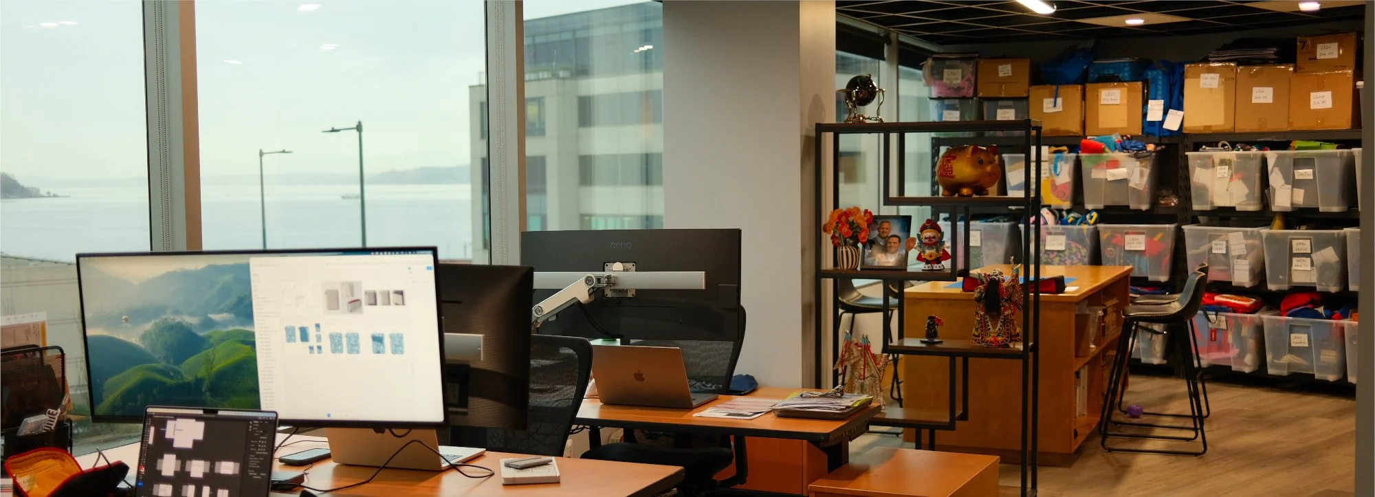 Carry Gear office with desks, monitors and view of the water.