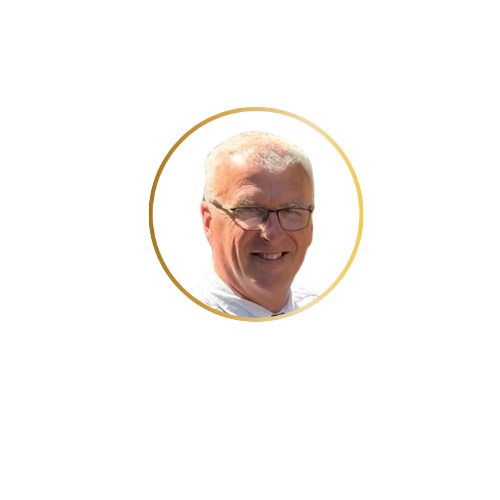 A smiling man with gray hair and glasses, wearing a white shirt.