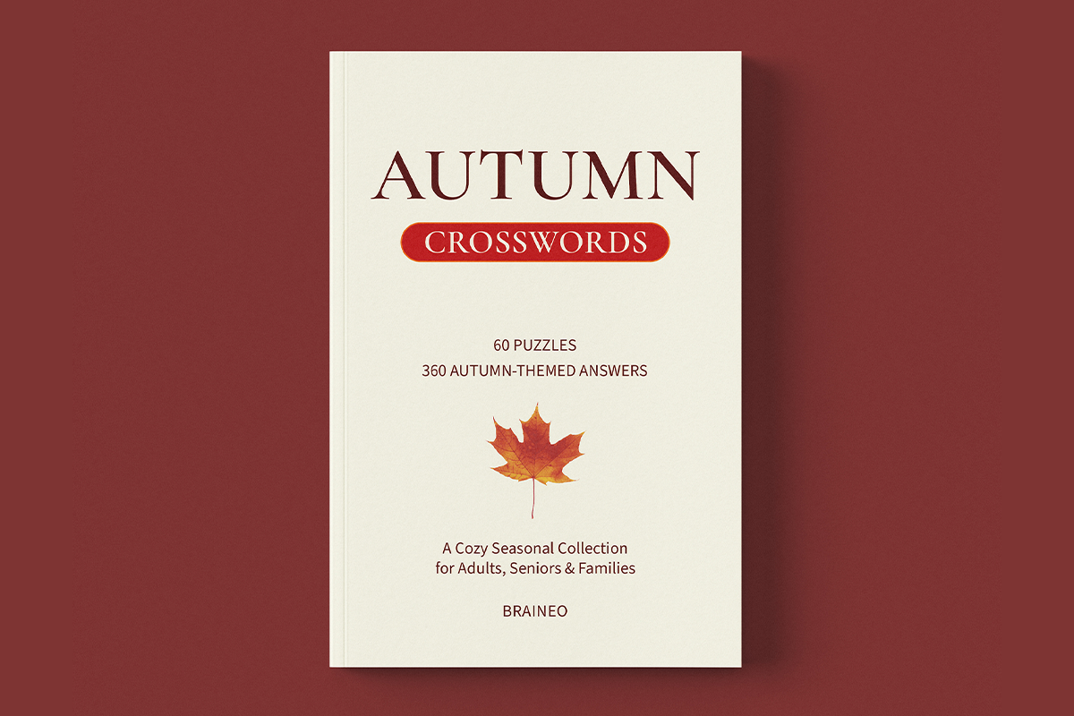 Autumn Crosswords paperback by Braineo with a cream-colored cover, maple leaf illustration, and 60 seasonal crossword puzzles.