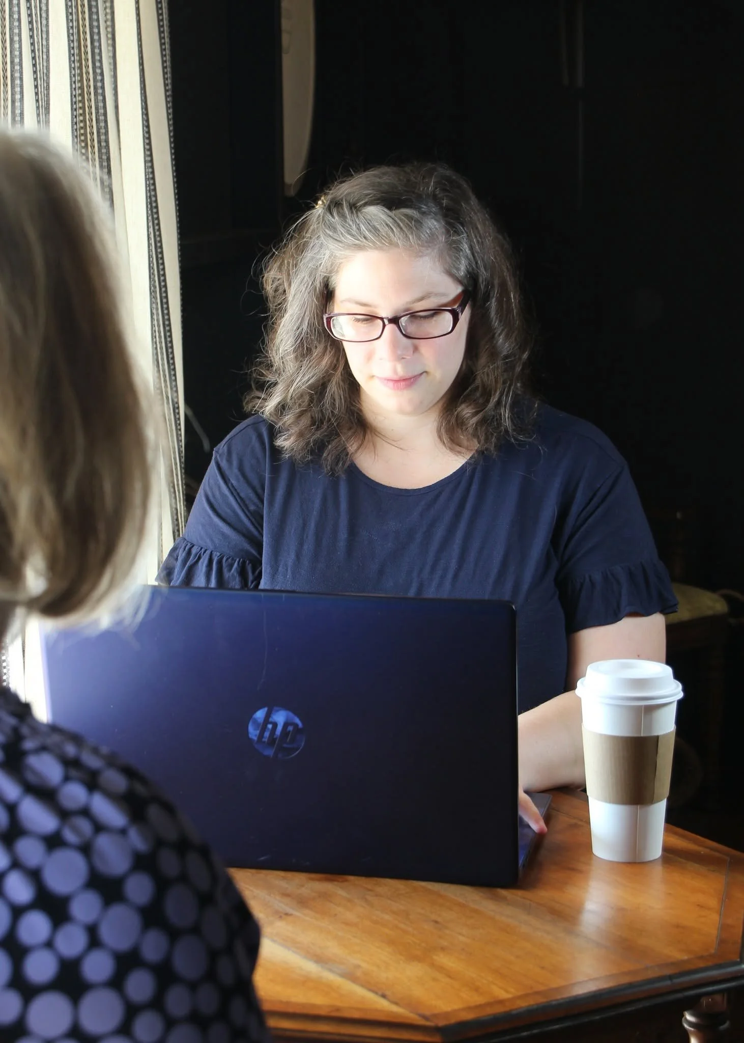 Woman sitting in front of blue laptop | Website Designer in Mountain View Missouri