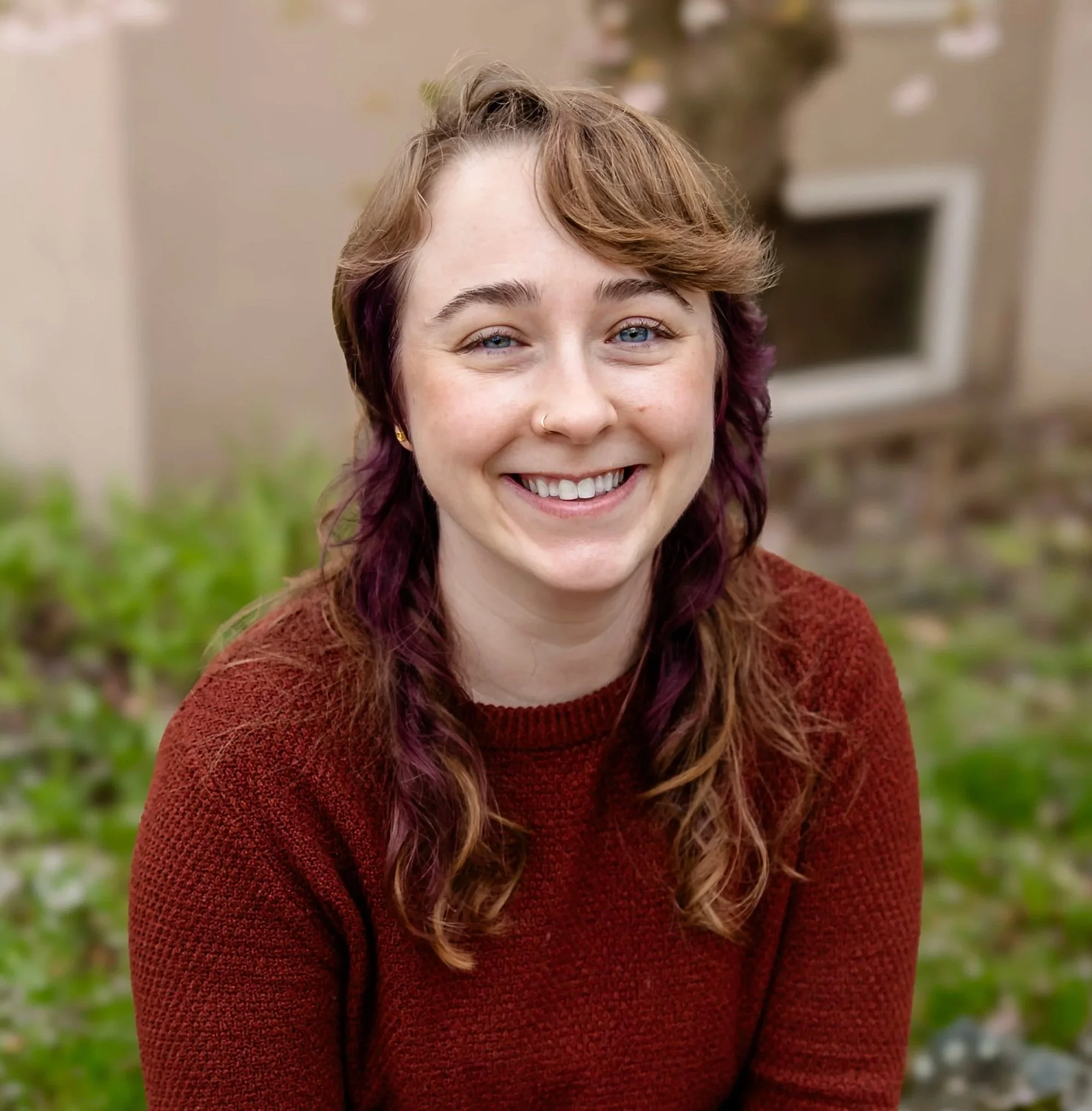 white person long brown and purple hair smiling. cambridge & boston based doula