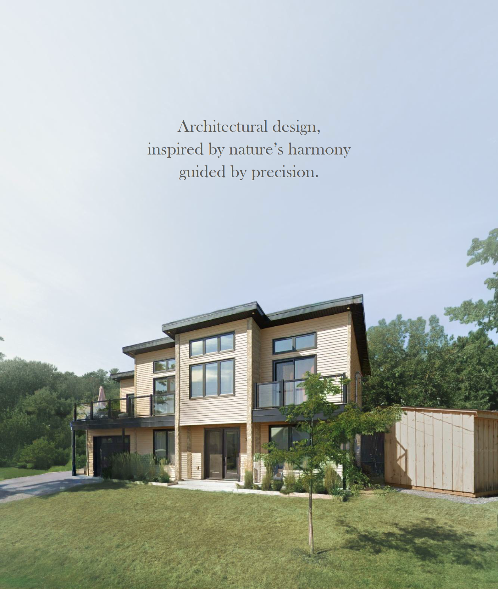 Coastal modern two-story house with large windows, balcony, surrounded by greenery and trees, with a blue sky above by Triumph Design in Kingston, Ontario.