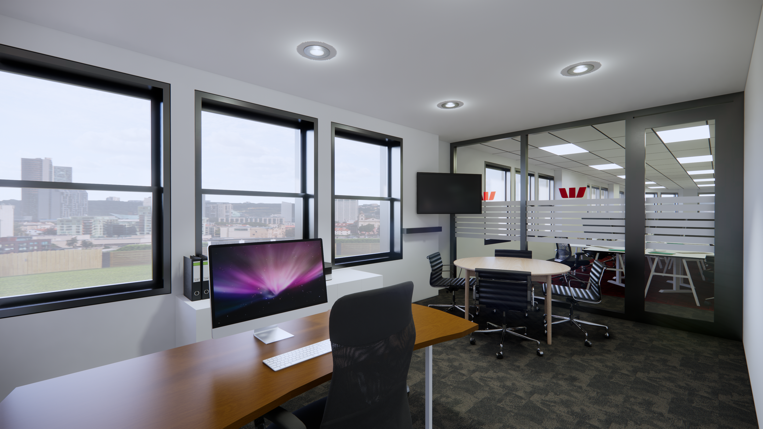 Modern office space with large windows, a computer on a wooden desk, a TV mounted on the wall, and a glass partition separating a conference area with round tables and chairs.