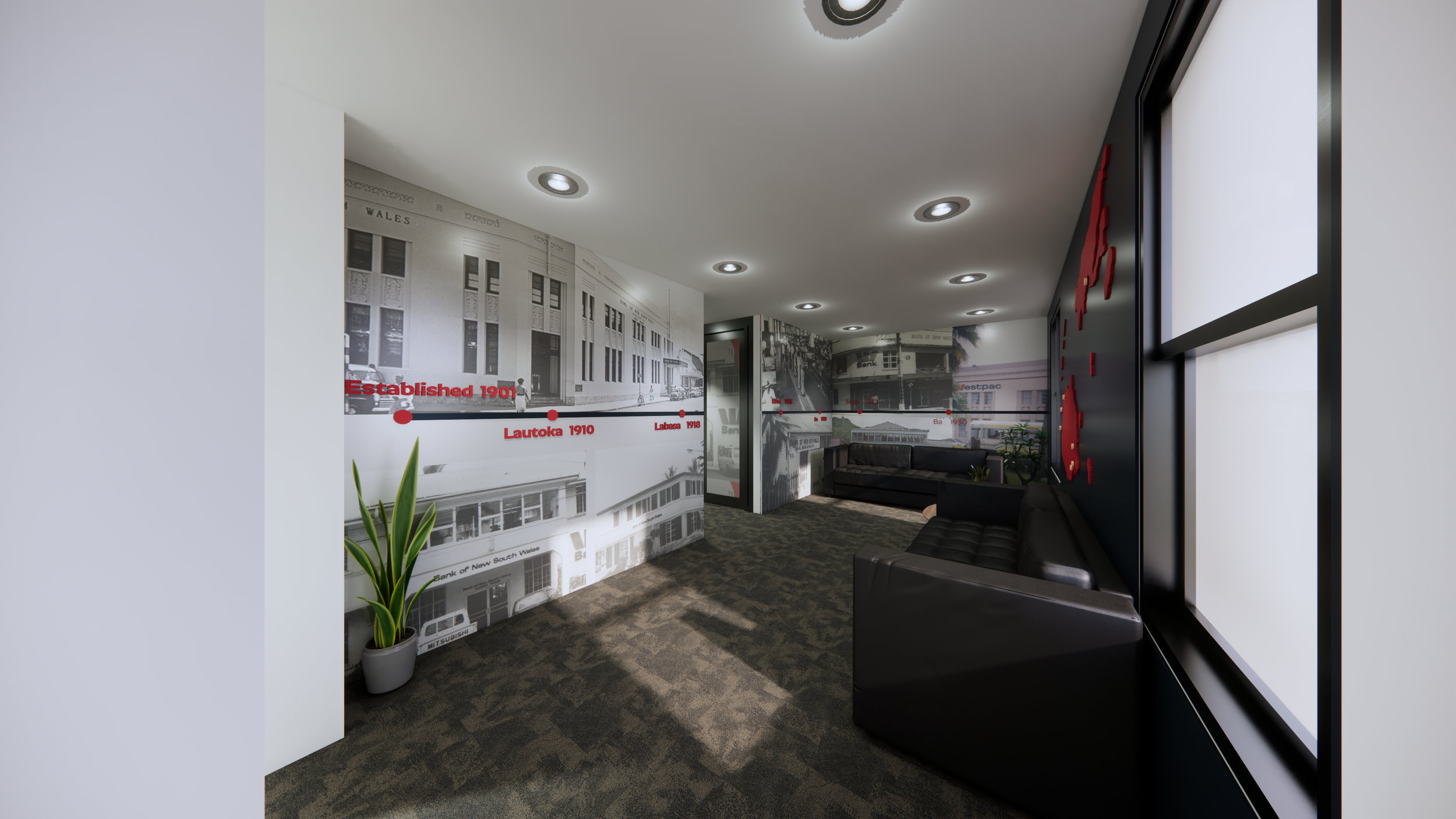 Indoor waiting area with black leather couches, a potted plant, black and white historical photos on the walls, and a large window.