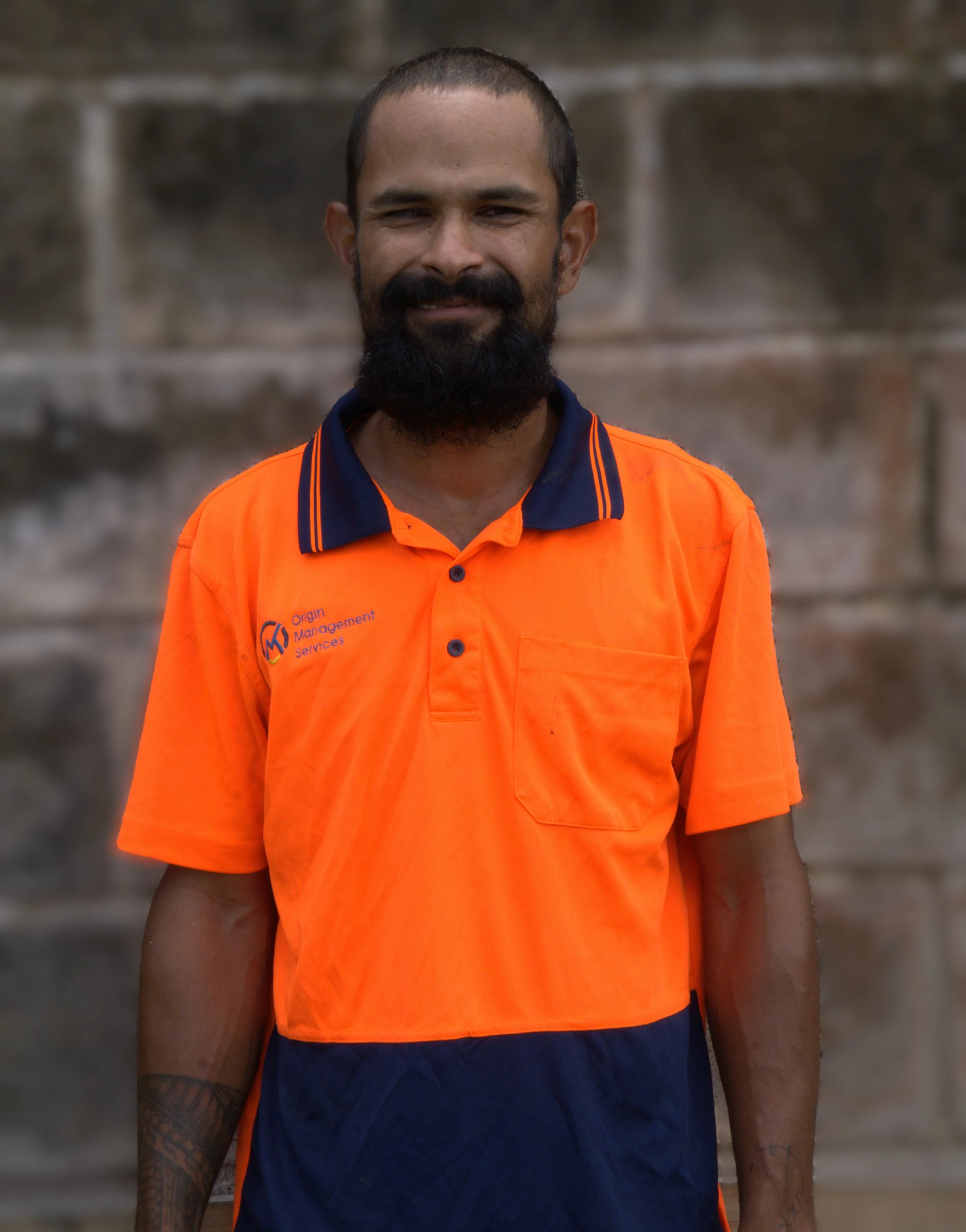 Construction man standing in front of retaining wall.