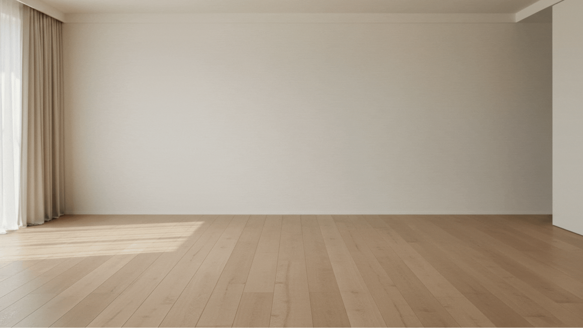 Empty room with wooden floor, beige walls, and a window with cream curtains on the left side.