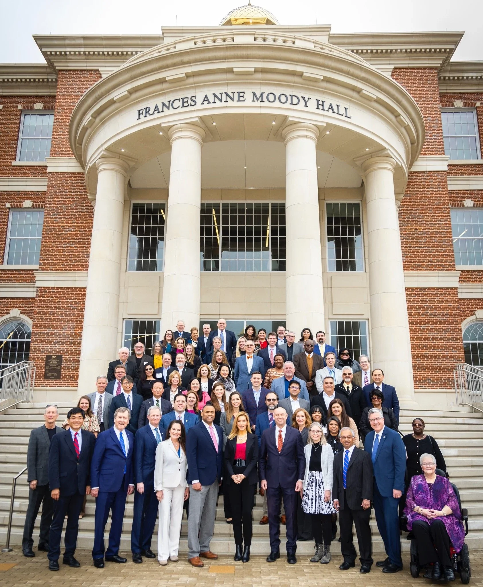 Group of people standing on steps in front of Frances Anne Moody Hall building