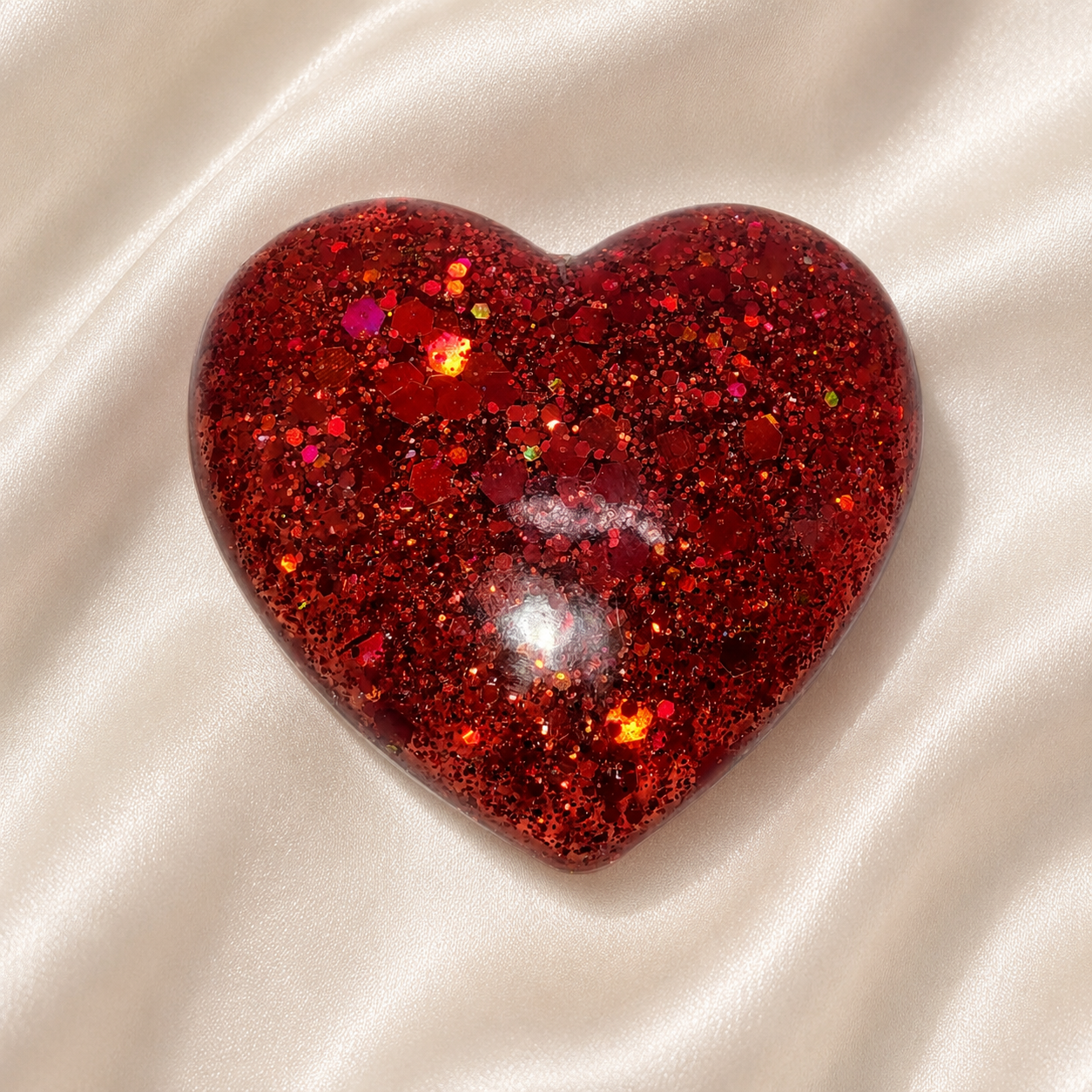 Generated image: Glittering red heart on satin fabric.png