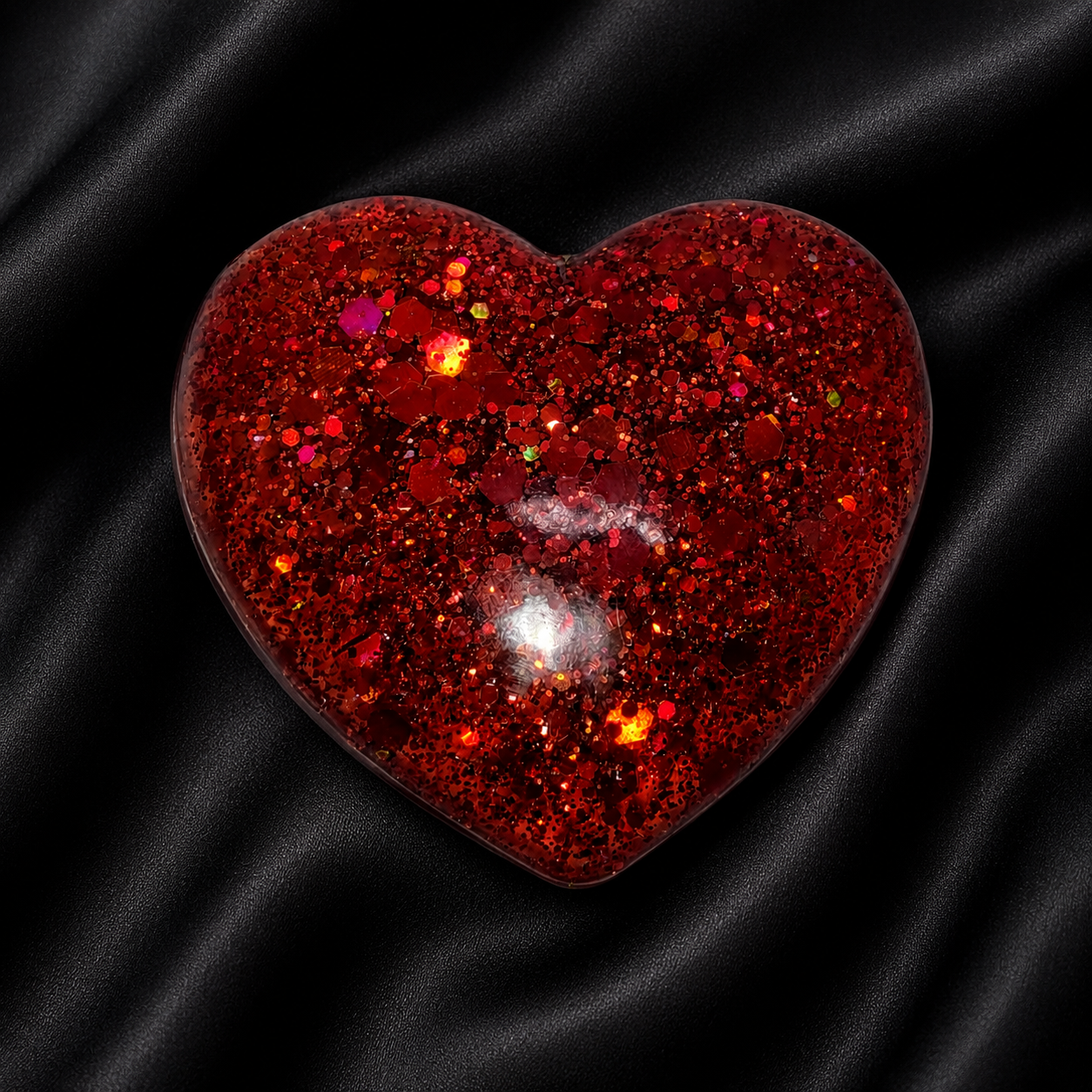 Generated image: Shiny red heart on black satin.png