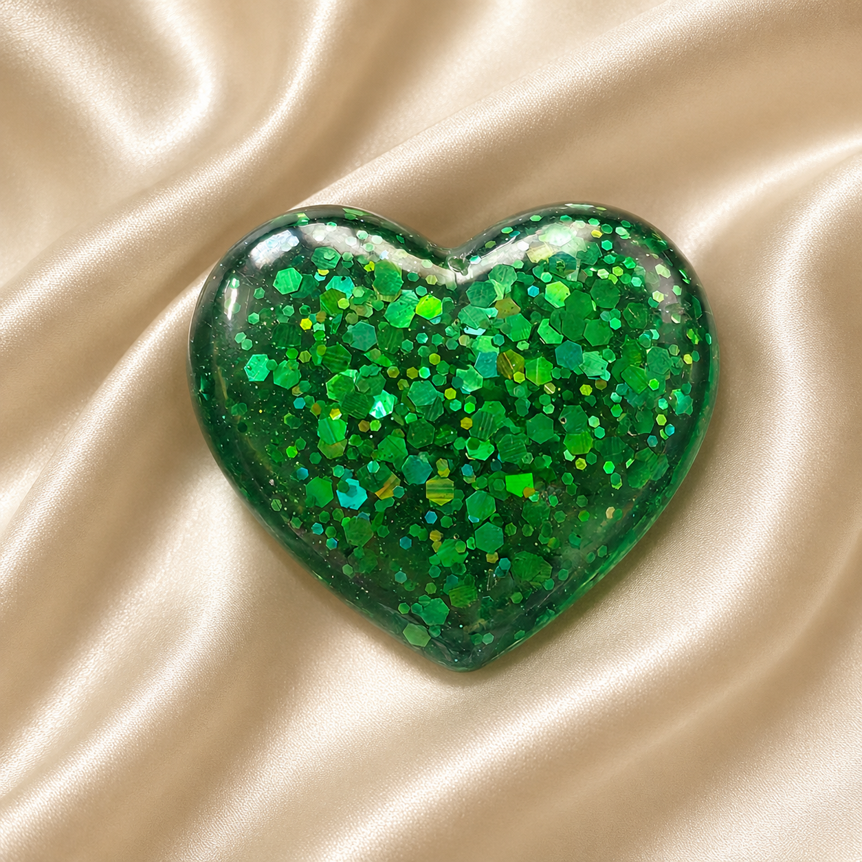 Generated image: Glittery green heart on satin fabric.png