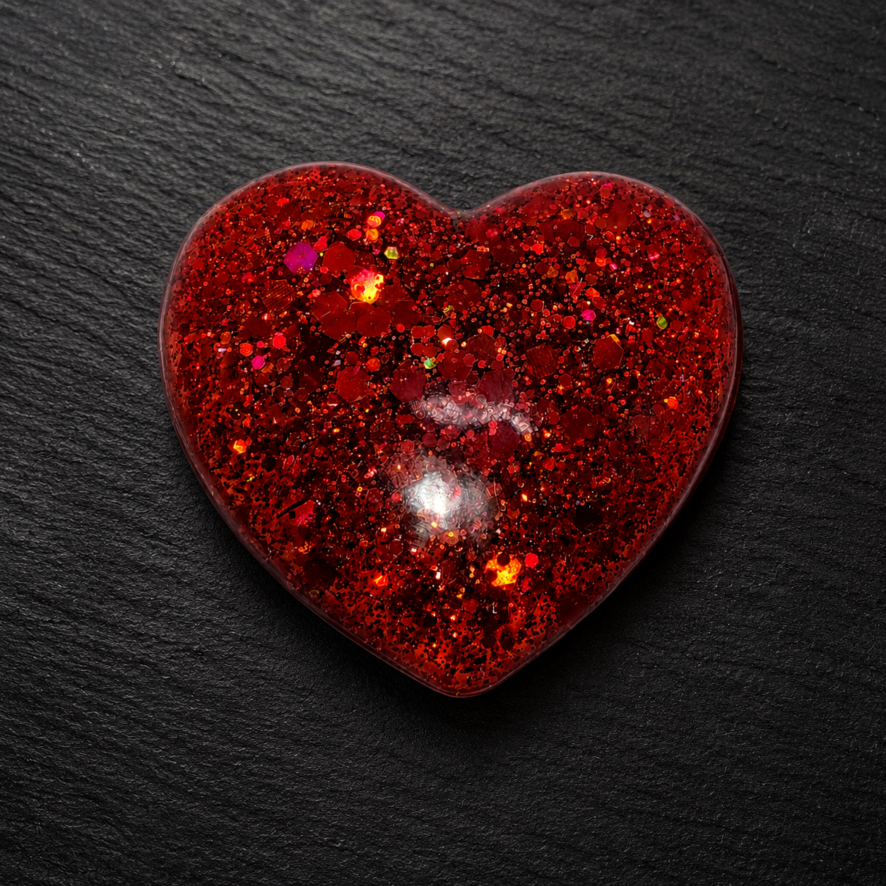 Generated image: Glittering red heart on dark surface 2.png