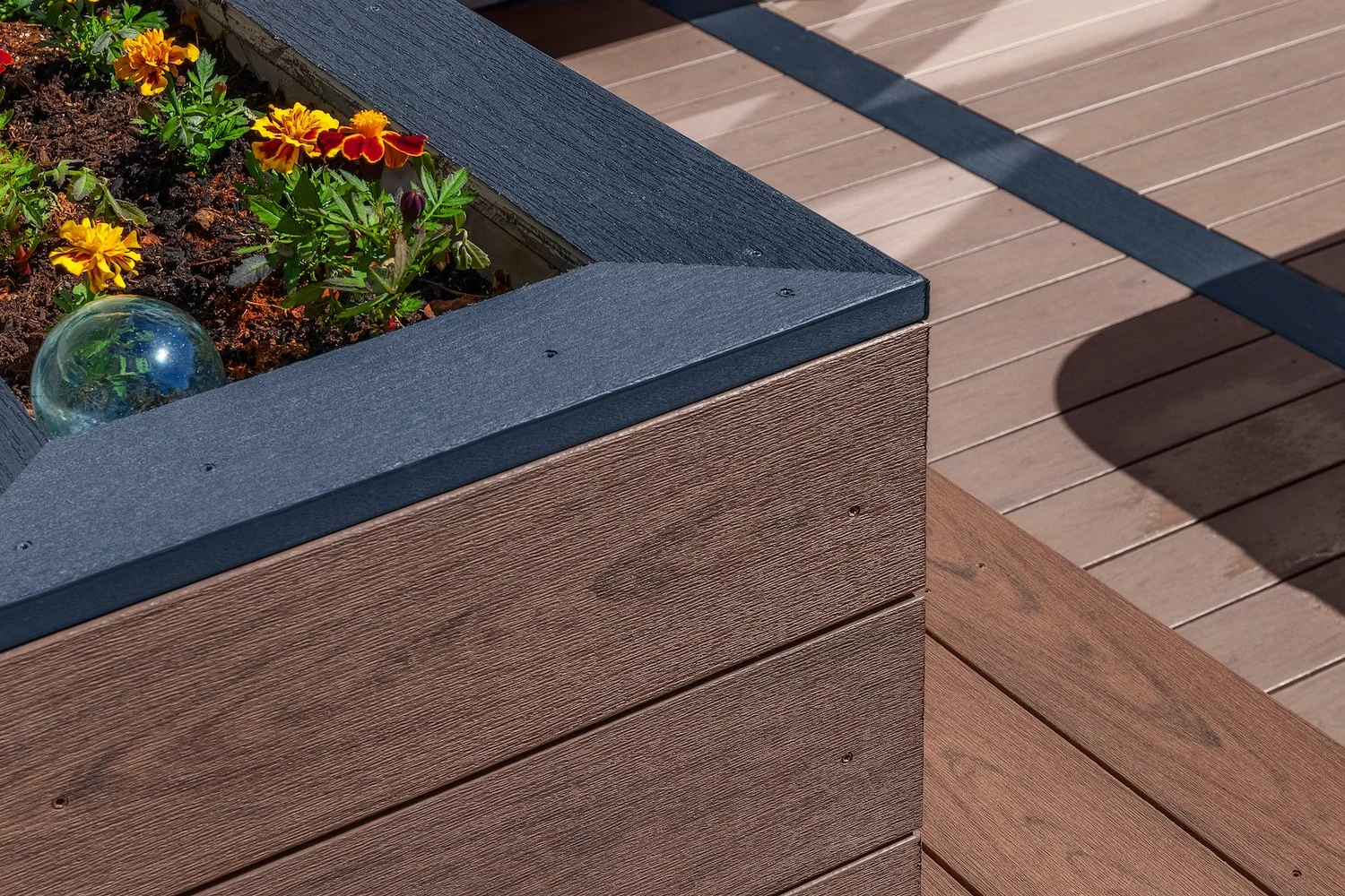 DECK DETAILS
-Custom planter box/bench combination
-Surfaced in Deckorators Mesquite 
-Accented in Deckorators Dark Slate