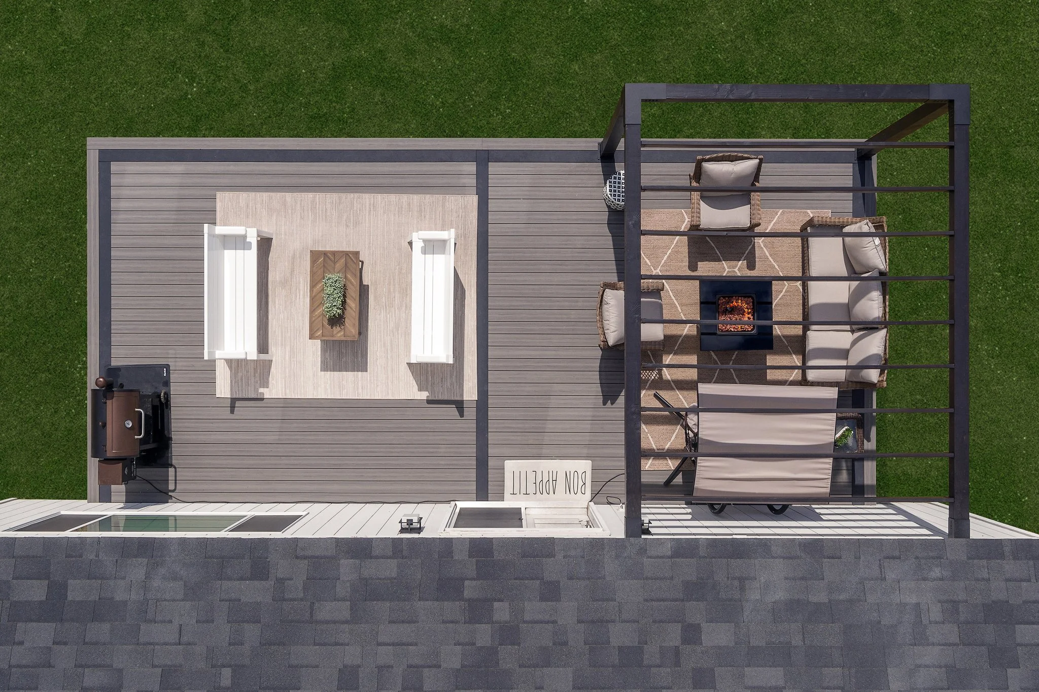Top-down view of a rooftop patio with seating area, fire pit, BBQ grill, and a 