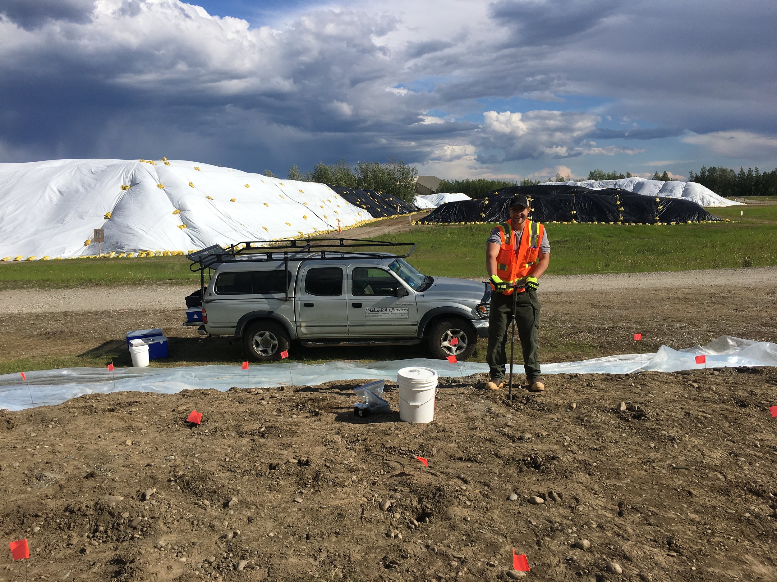 Man sampling stockpile at field site