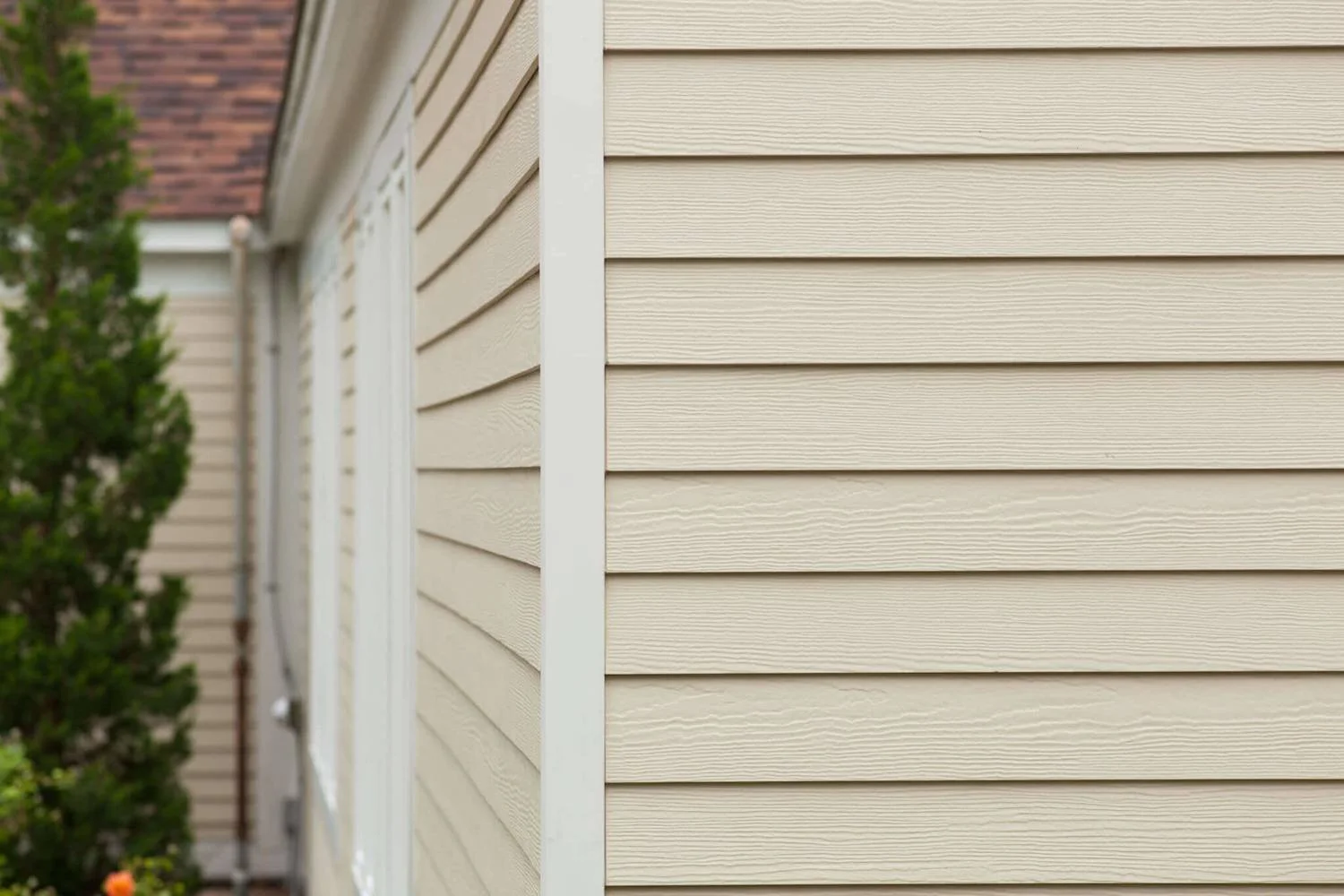 Close-up of beige vinyl siding on a house.