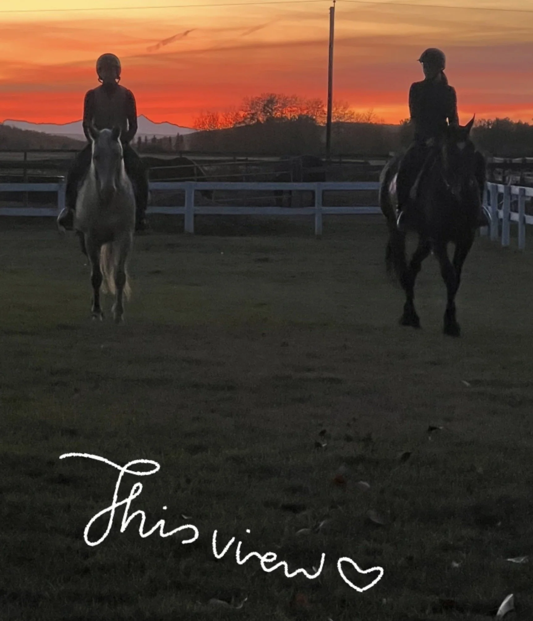 Two women riding horses on a racetrack during sunset, with a vibrant orange and pink sky and mountains in the background, and decorative script and heart overlay at the bottom.