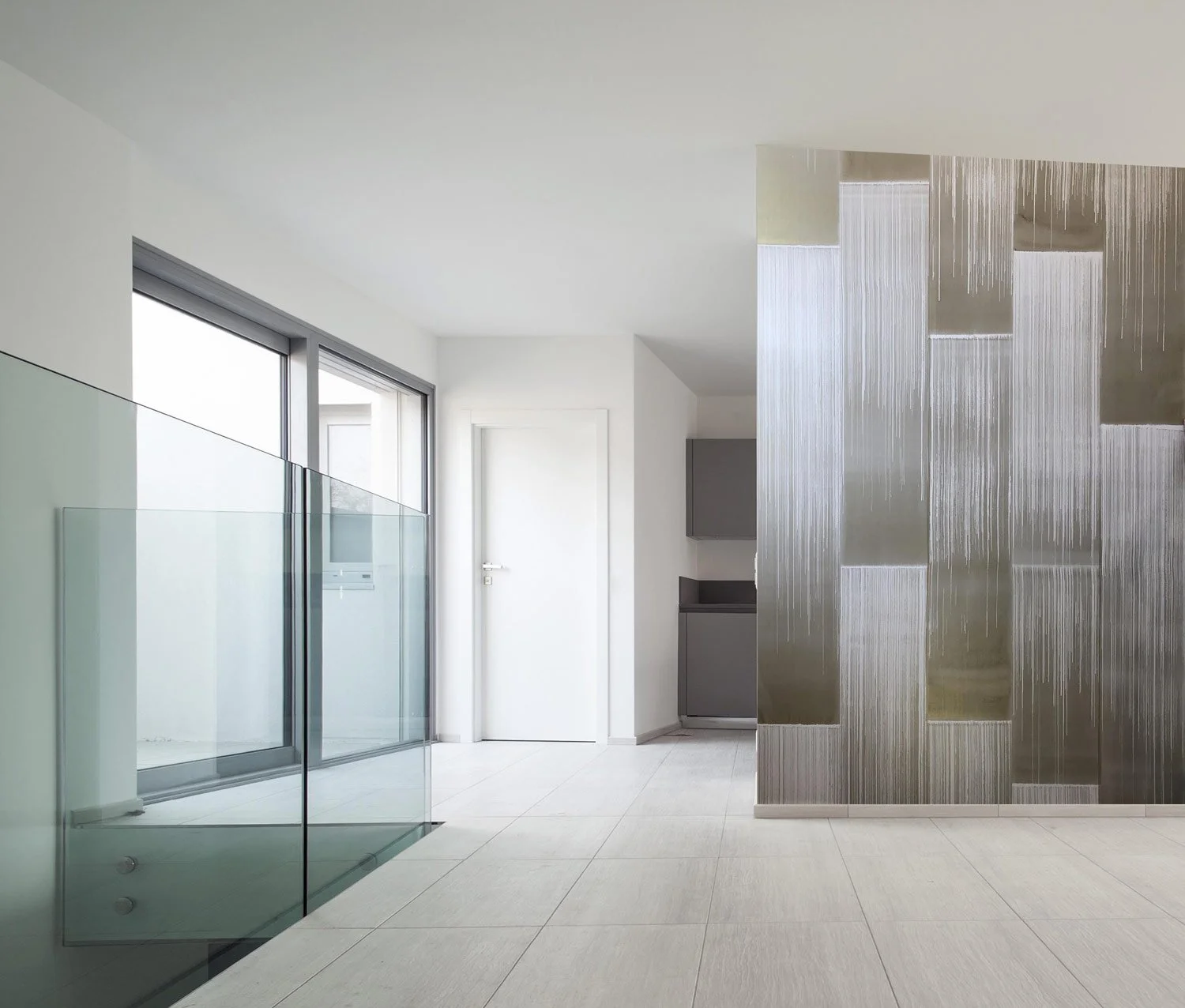  Decca Lake  • SKU 19-0752 • The alchemy of ink, mica and metal powders are revealed through bold shimmering, vertical brush strokes on a base of soft matte marble plaster.