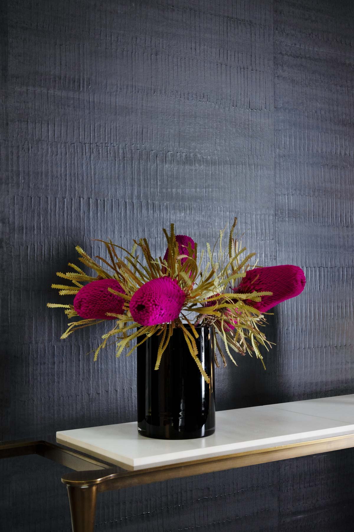  Lotic Charcoal  • SKU 11-0066 • Bands of undulating polished plaster finished with beeswax, this paper is reminiscent of waves at sea or reptilian skin.