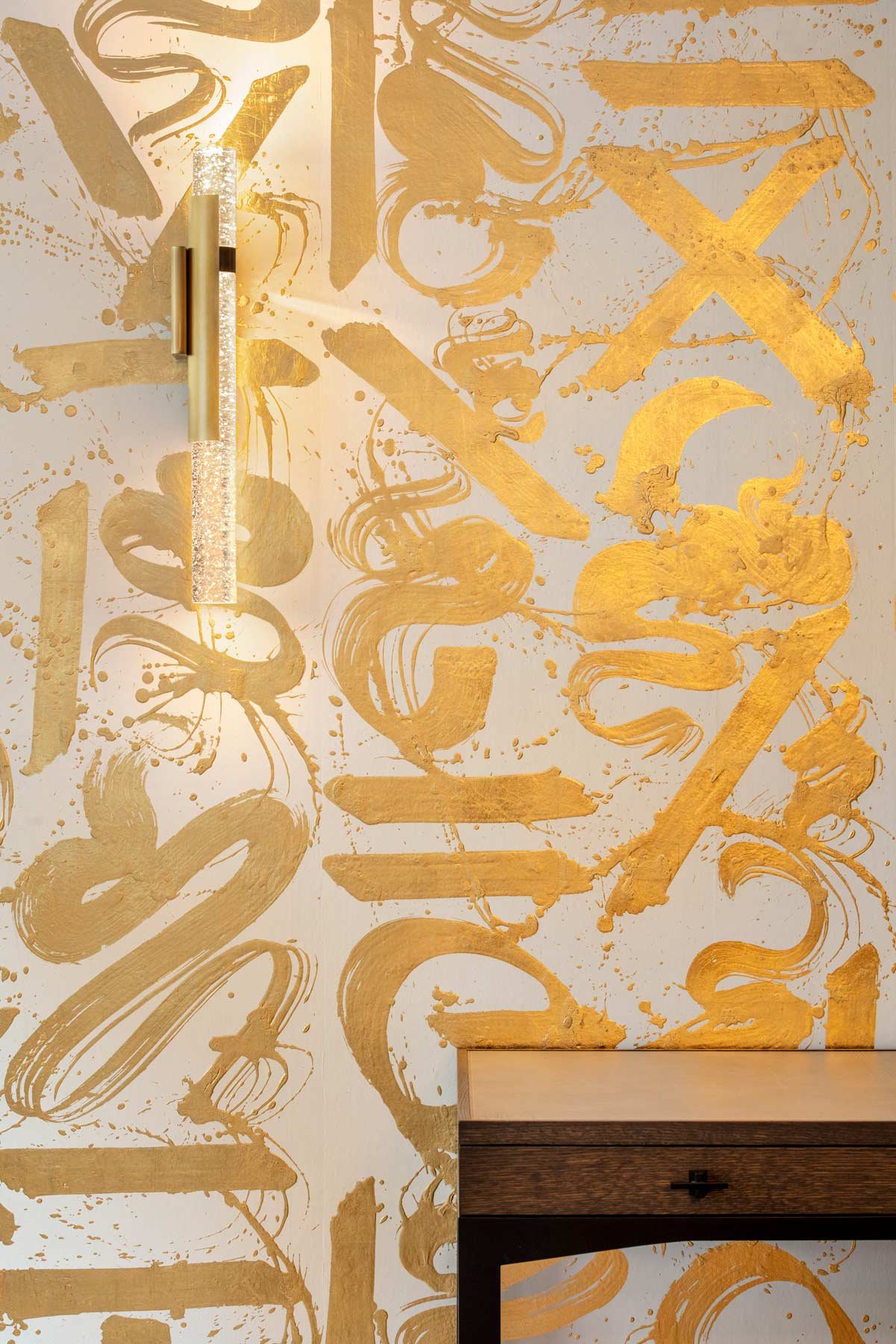  Basho Leaf Salt Gold  • SKU 17-0531 • Calligraphic strokes of hand-applied gold leaf on marble plaster create a space that is both precious and bold.
