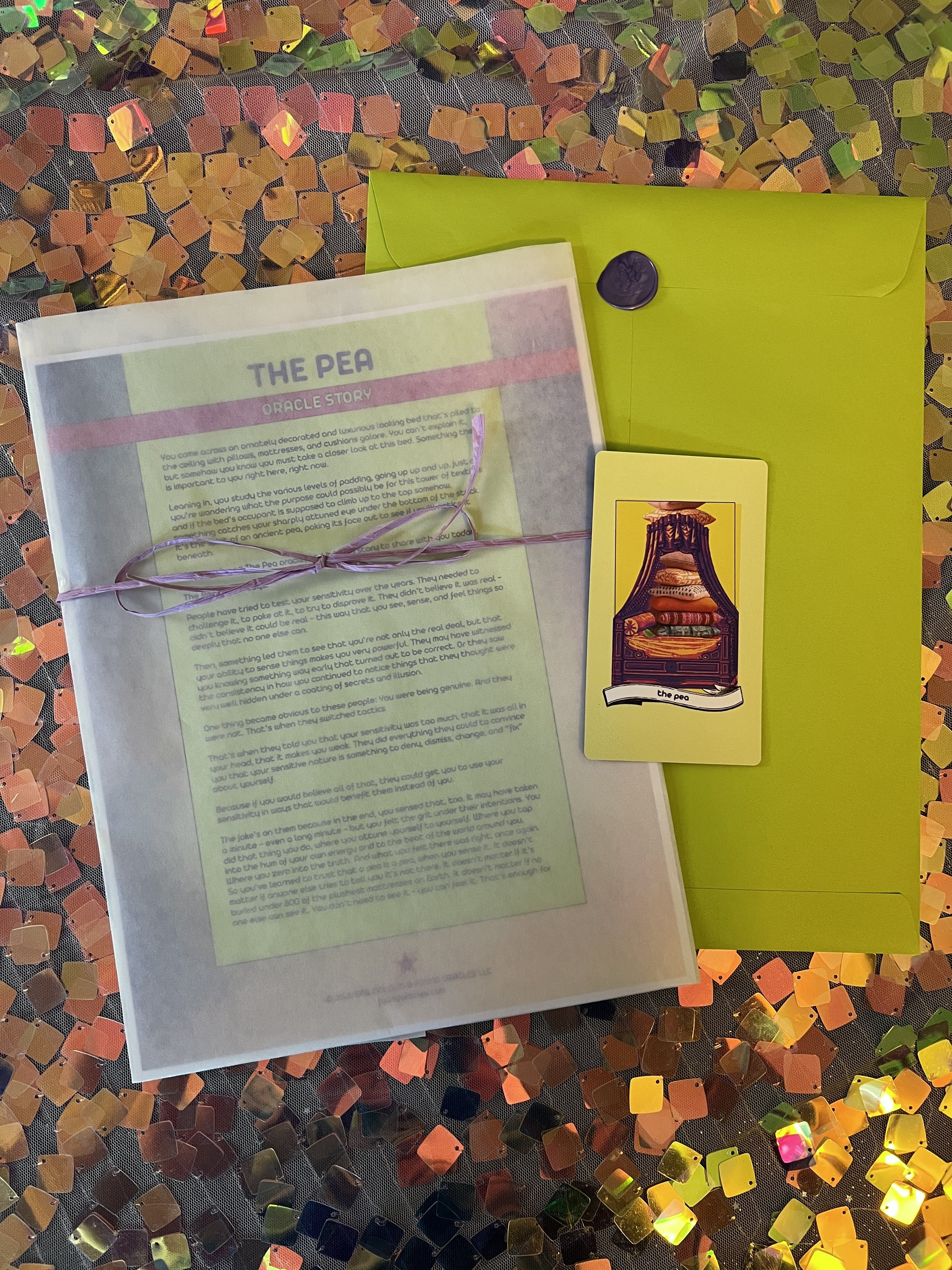 Flat lay shot of The Pea printed story card and story sheet from Found Oracles with purple wax sealed green envelope behind.