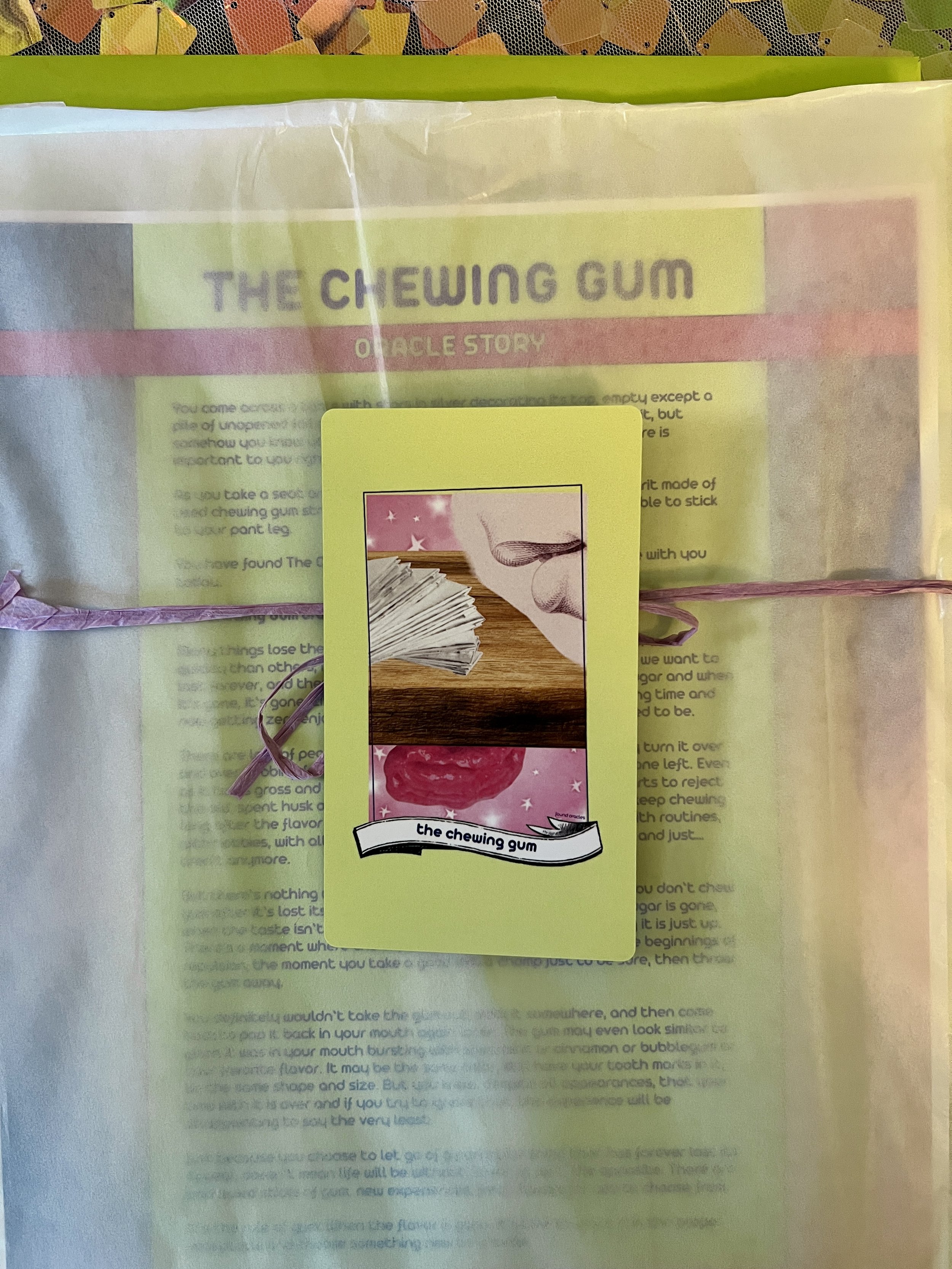 The Chewing Gum individual printed card and story sheet from Found Oracles shown bundled up with the card on top.