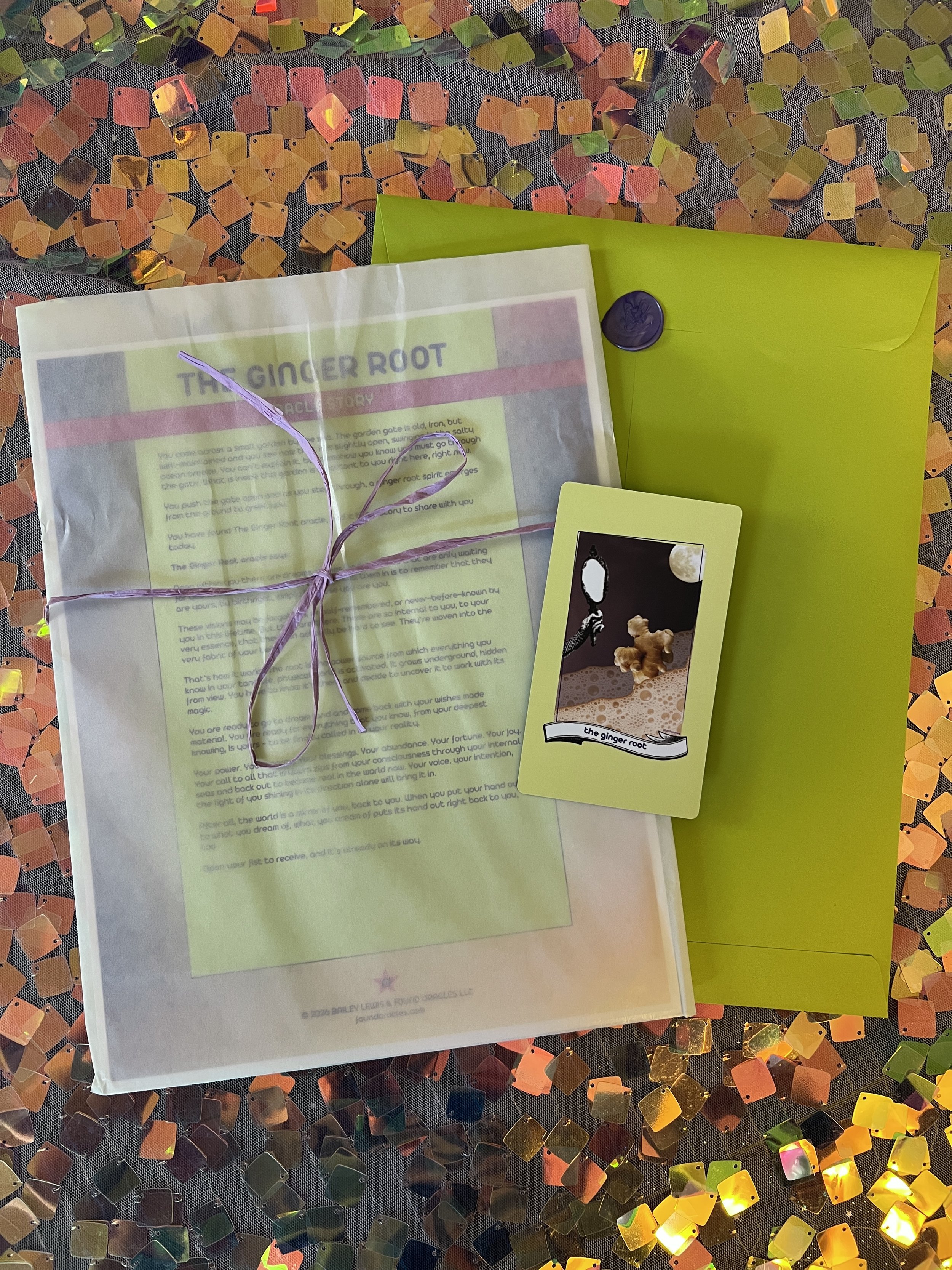 Flat lay shot of The Ginger Root printed story card and story sheet from Found Oracles with purple wax sealed green envelope behind.