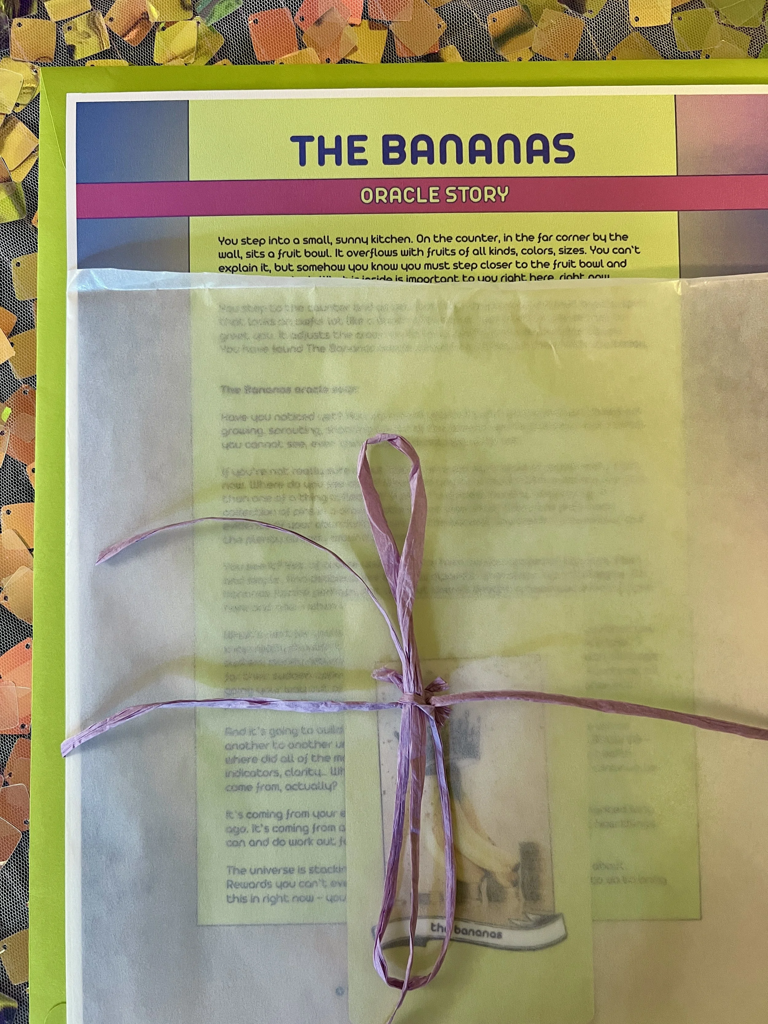 The Bananas from Found Oracles printed story sheet peeking out of its glassine sleeve with story card visible inside.