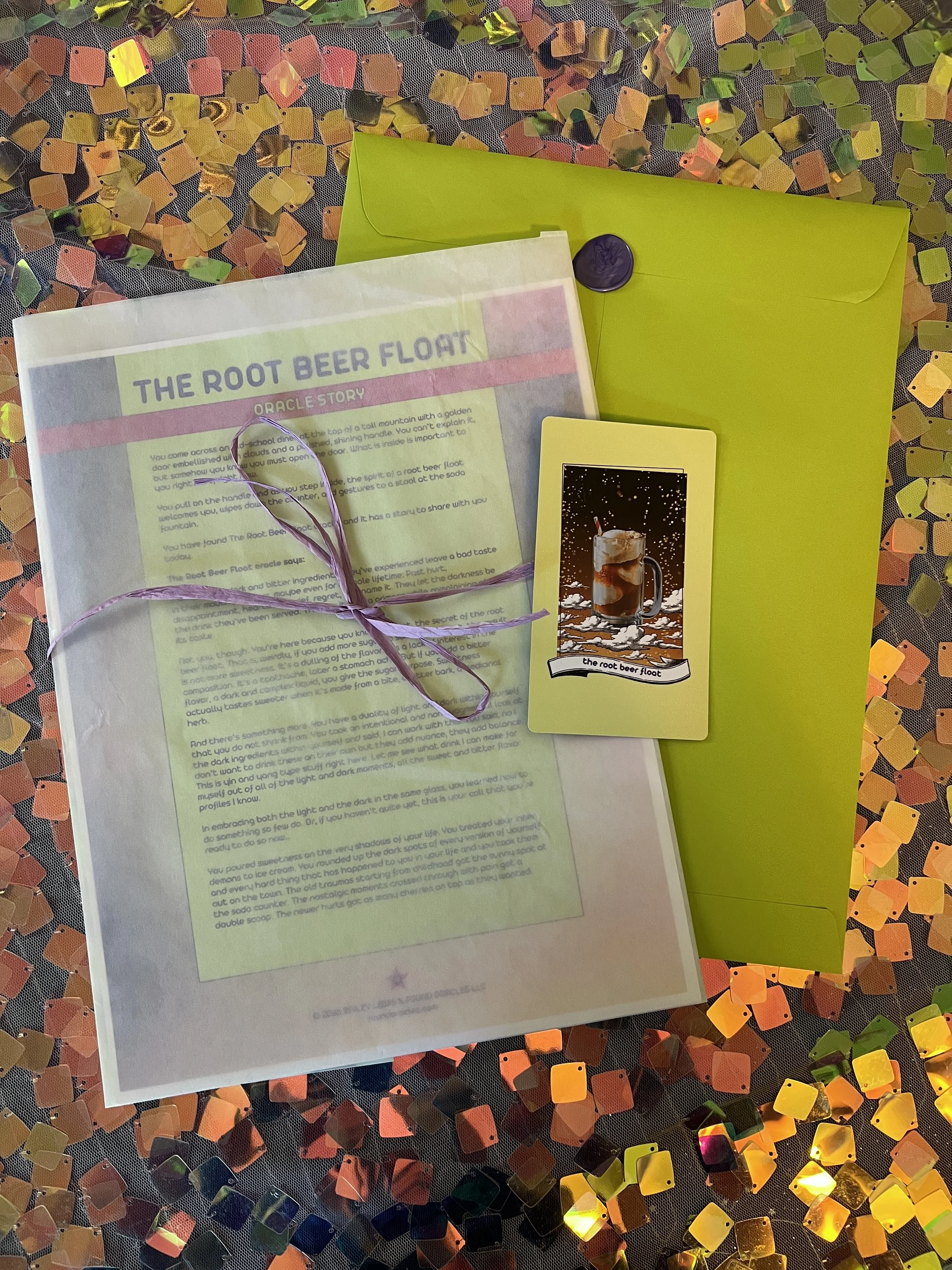 Flat lay shot of The Root Beer Float printed story card and story sheet from Found Oracles with purple wax sealed green envelope behind.