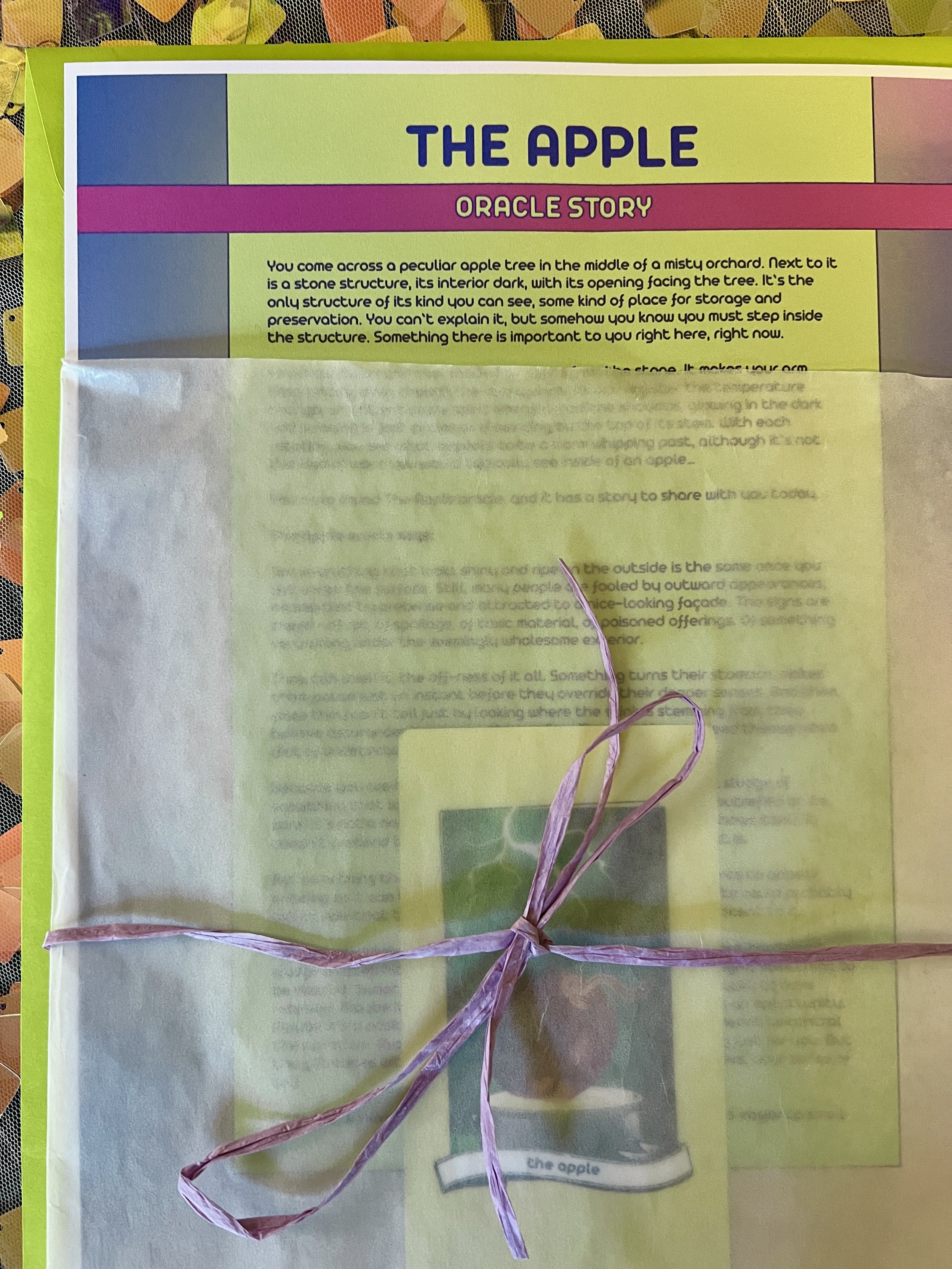 The Apple from Found Oracles printed story sheet peeking out of its glassine sleeve with story card visible inside.