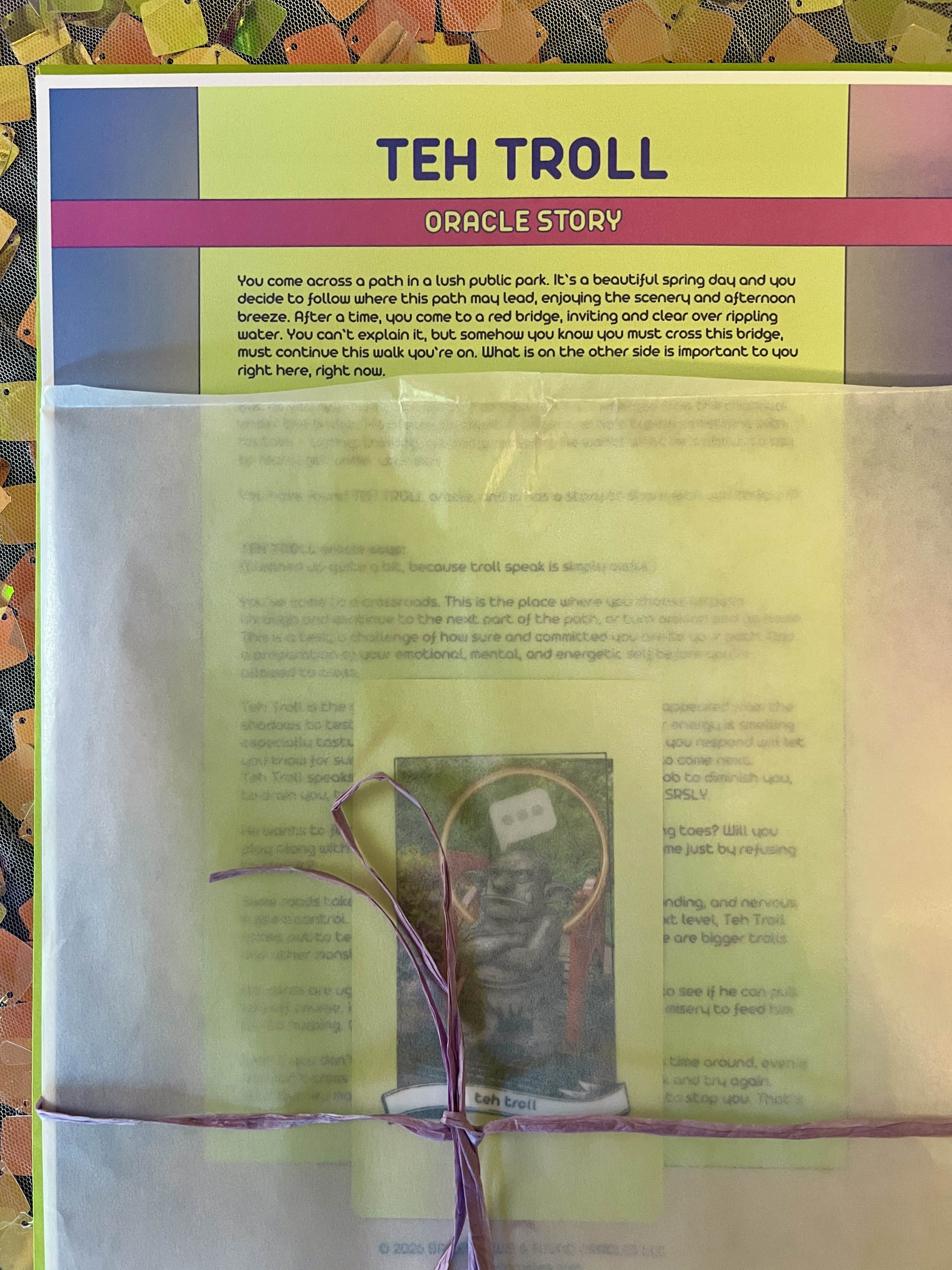 Teh Troll from Found Oracles printed story sheet peeking out of its glassine sleeve with story card visible inside.