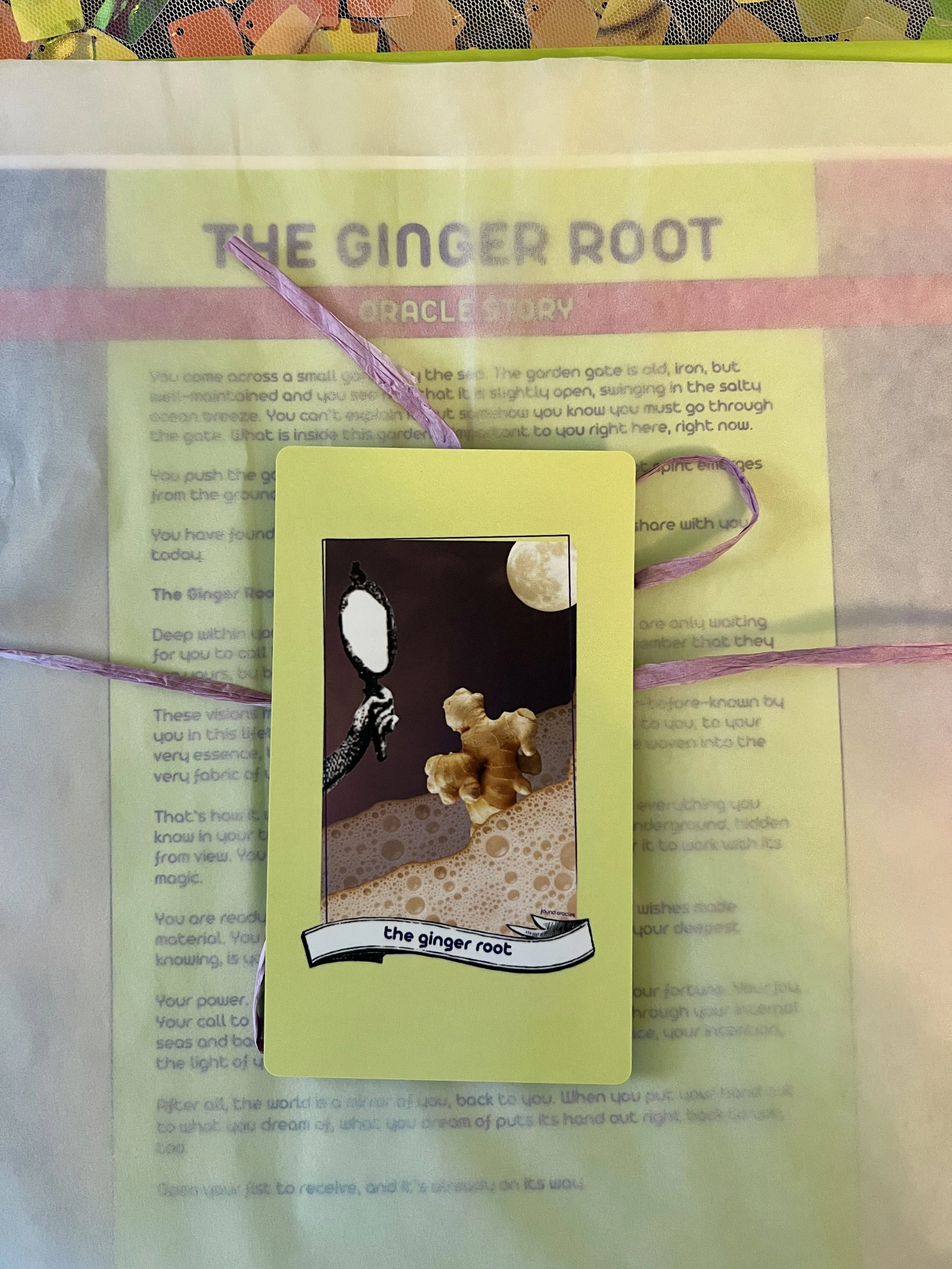 The Ginger Root individual printed card and story sheet from Found Oracles shown bundled up with the card on top.