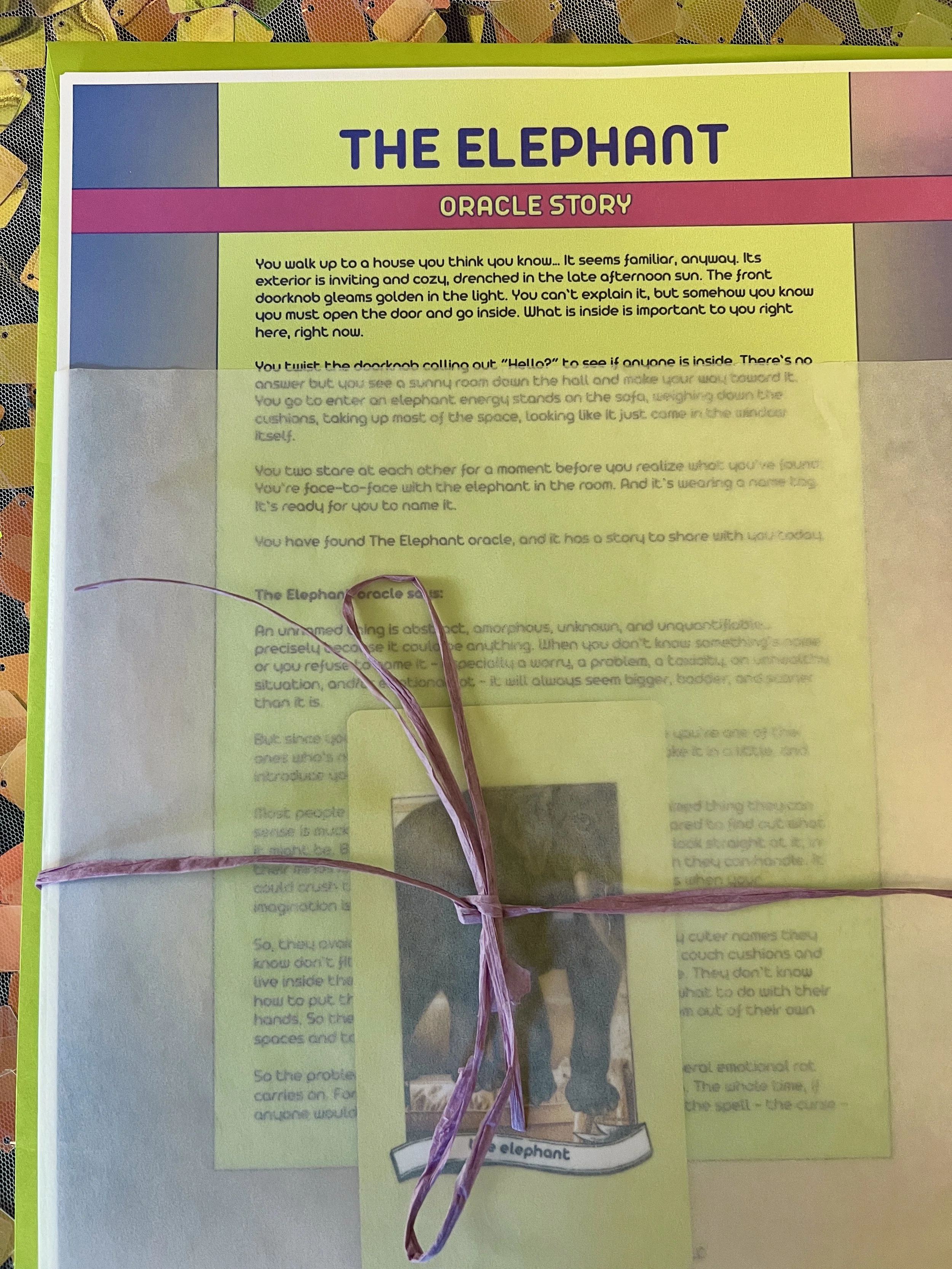 The Elephant from Found Oracles printed story sheet peeking out of its glassine sleeve with story card visible inside.